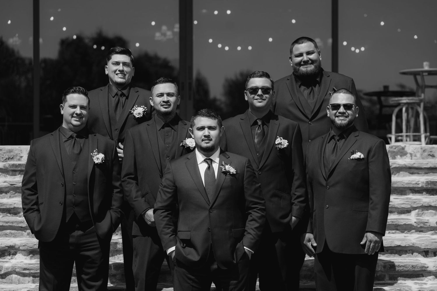 A series of black and white photographs showing a group of people posing together in formal attire.