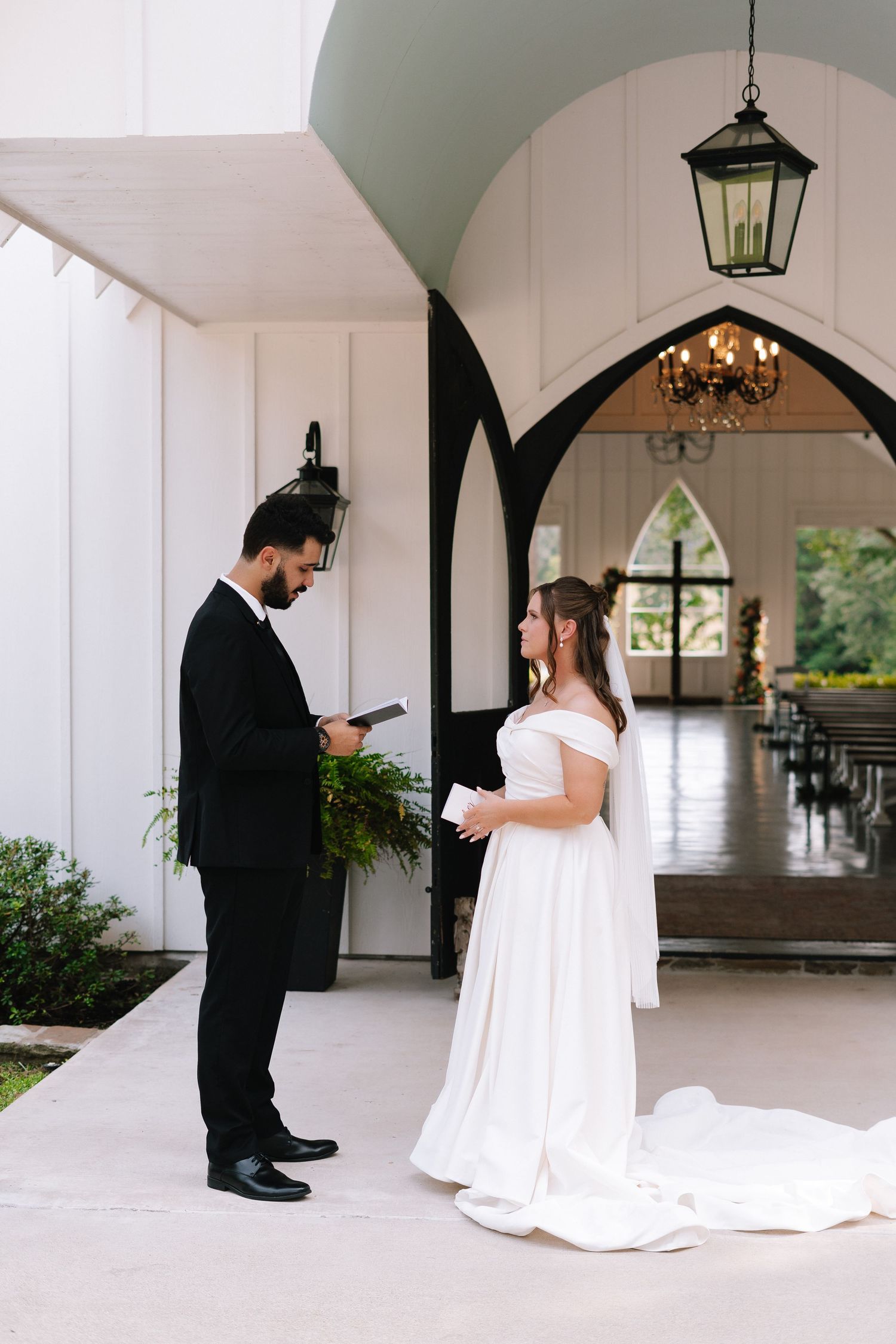 A series of wedding photos showing a couple texting during their first look in a white church hallway.