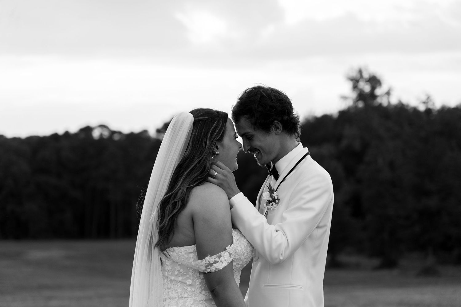A romantic black and white wedding photo collage showing tender moments between newlyweds in an outdoor setting.