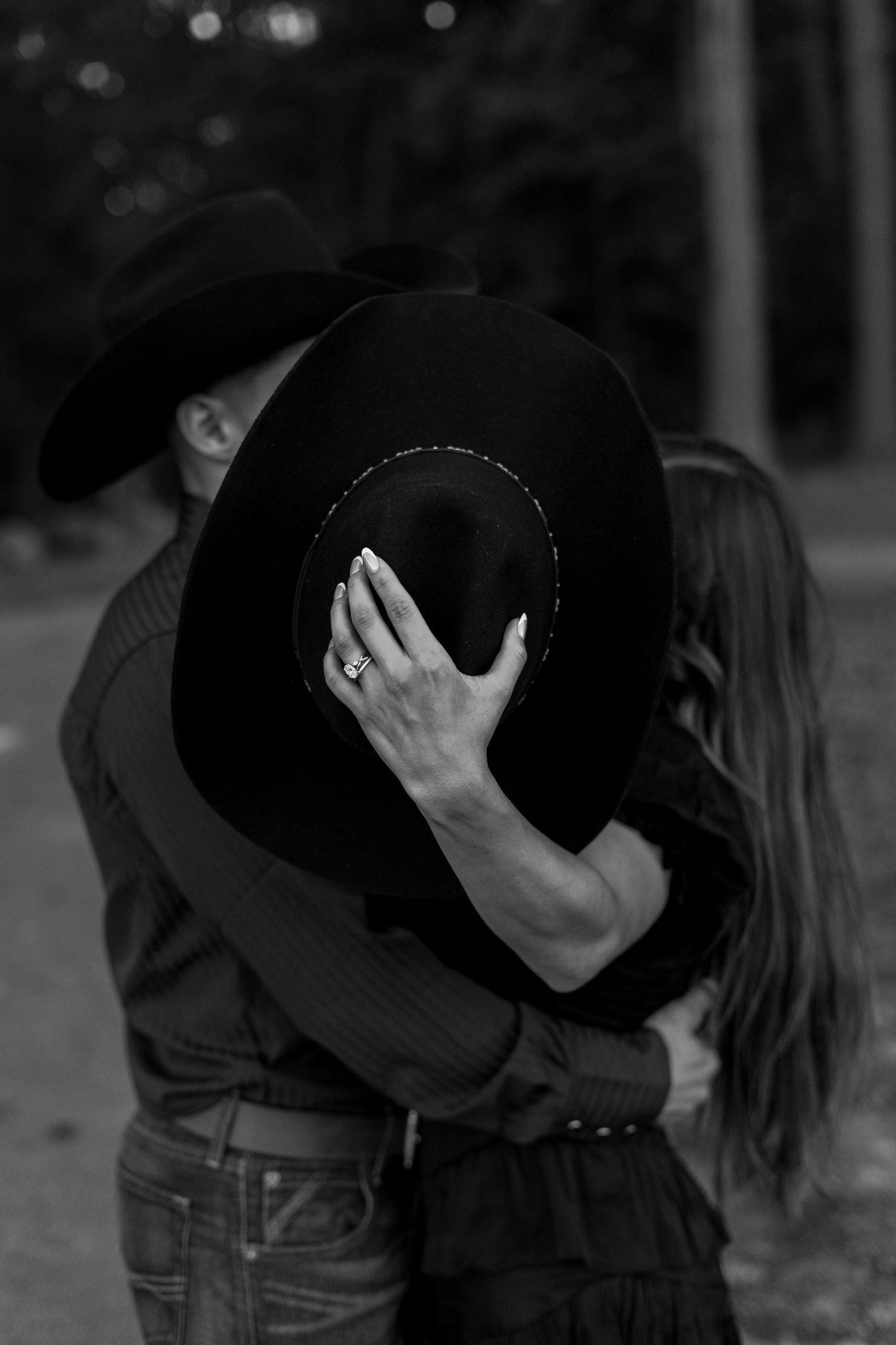 Black and white photos show a romantic couple sharing intimate moments while wearing cowboy hats.
