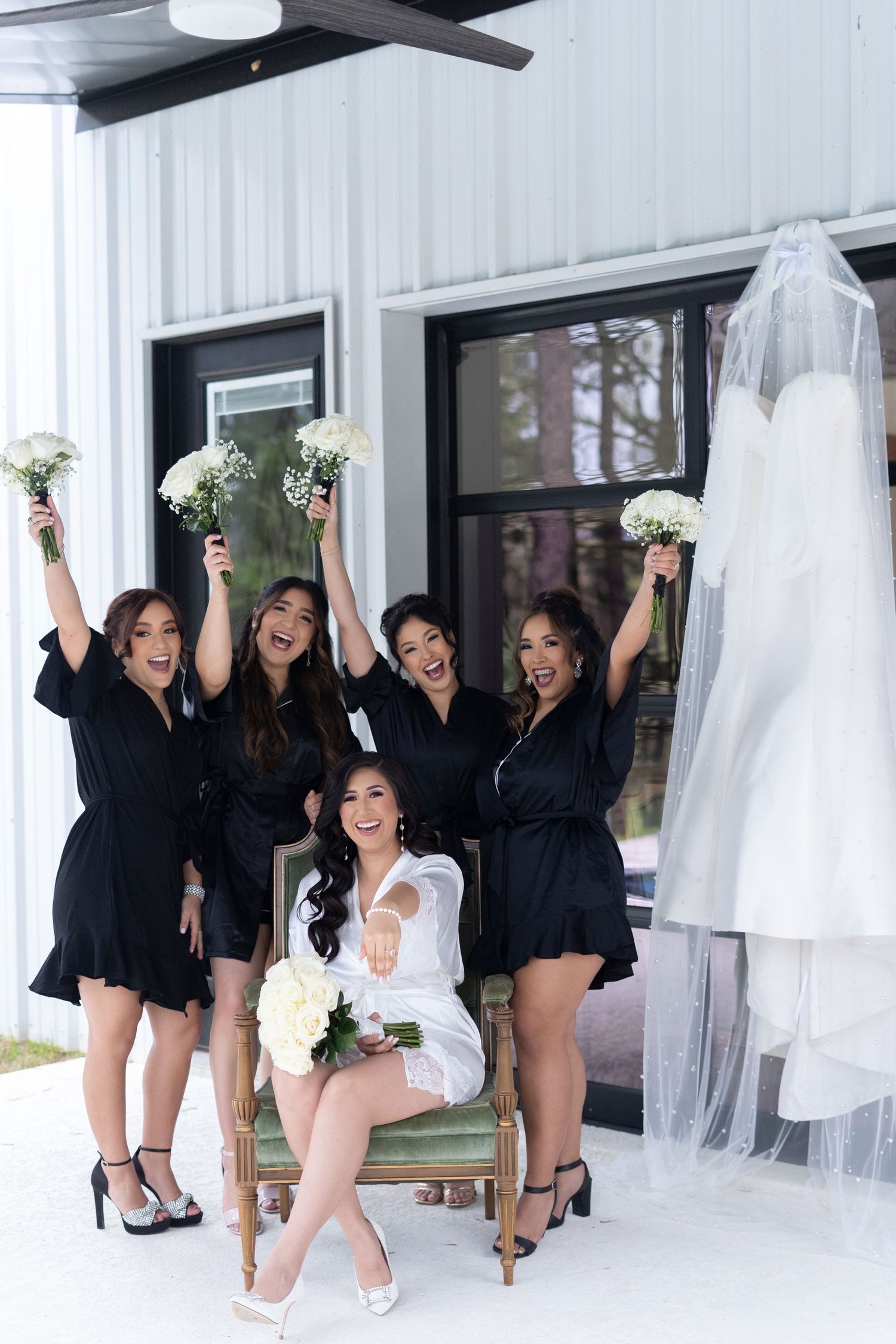 Bridesmaids in matching black robes pose together in a joyful sequence of celebratory photos in a bridal suite.