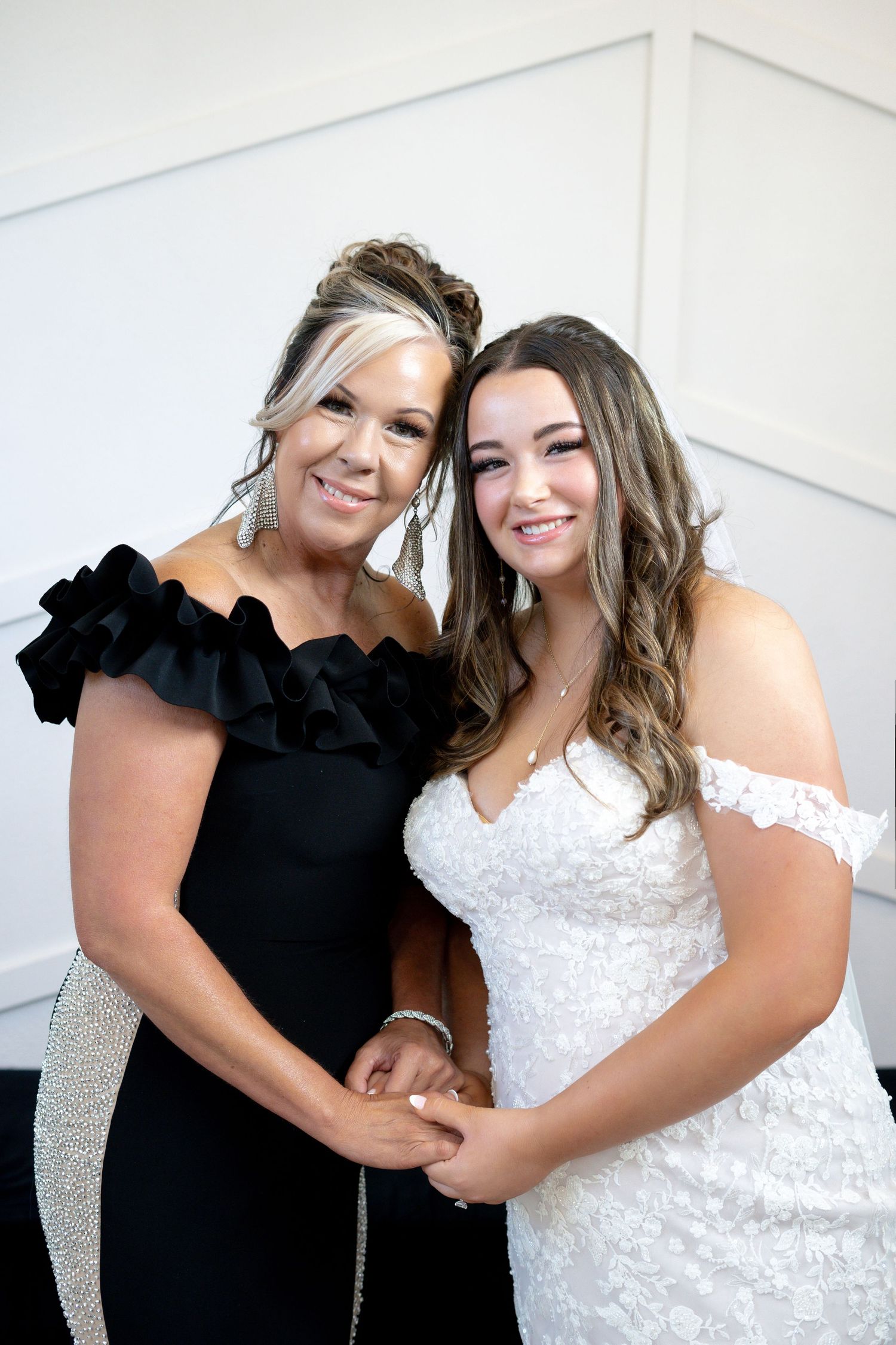 Two people pose together in black and white outfits, sharing joyful moments in a series of candid photos.