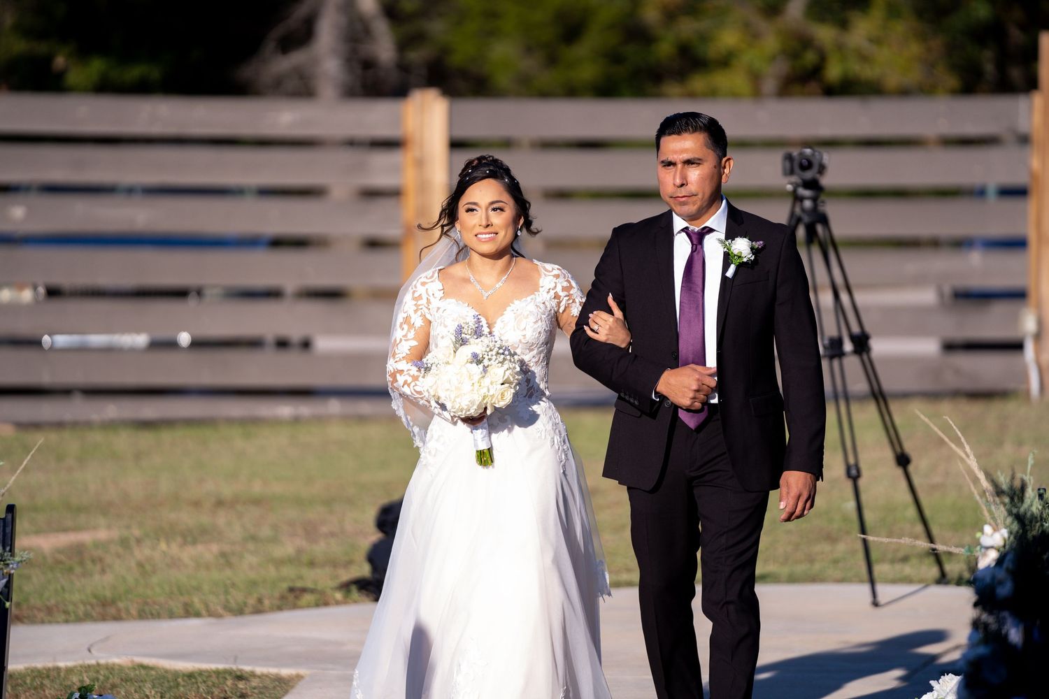 Wedding party walks together outdoors during golden hour photo session.