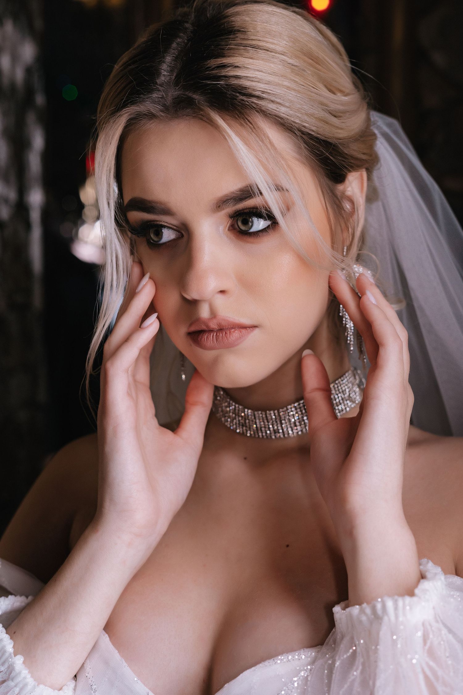 A bride wearing a white wedding dress and sparkling jewelry poses in a dramatic sequence of close-up portraits.