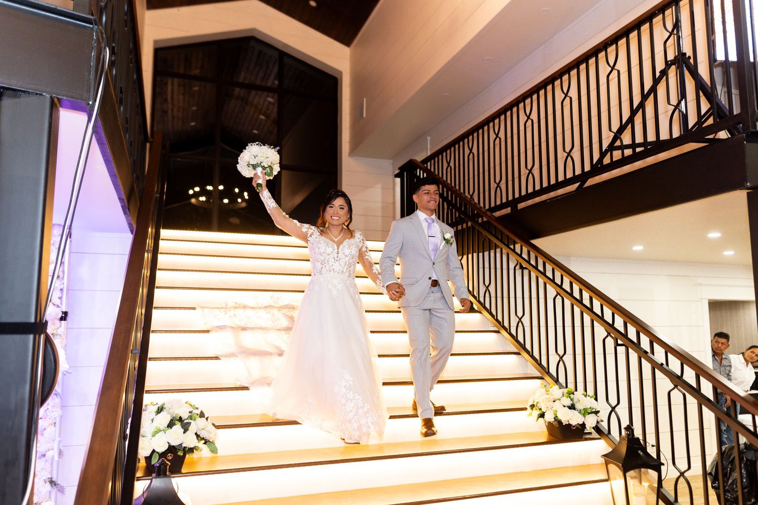 Modern staircase with LED lighting and dark wood accents in wedding venue.