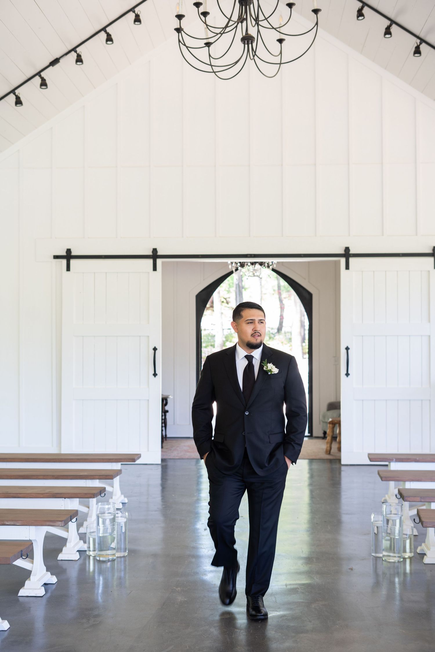 A sequence of photos showing a person in a black tuxedo walking through an elegant white wedding chapel interior.