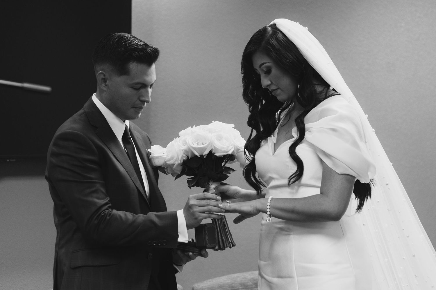 Black and white wedding photos showing romantic moments between newlyweds during their special day celebration.