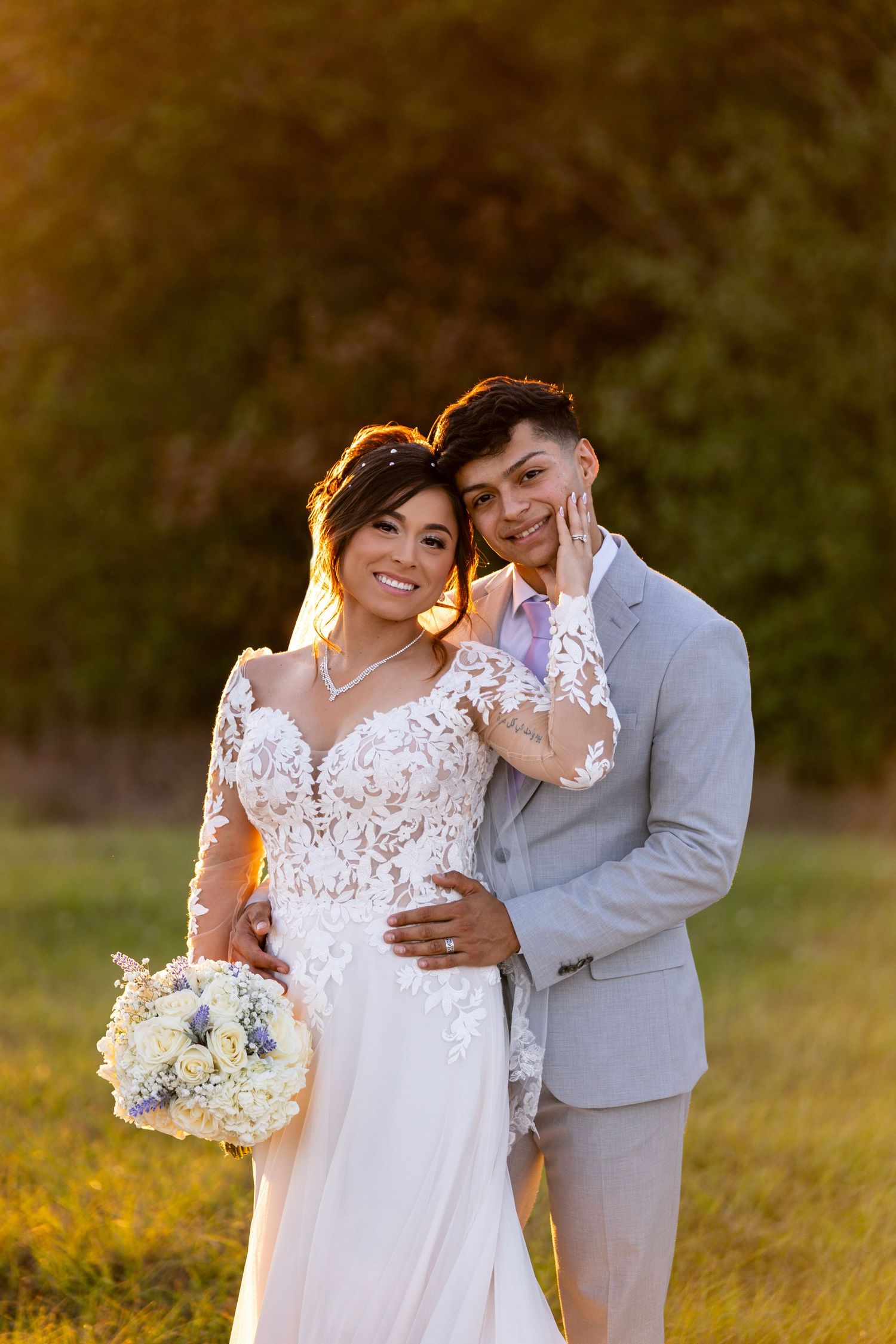 Romantic sunset wedding portraits in a field with golden light.