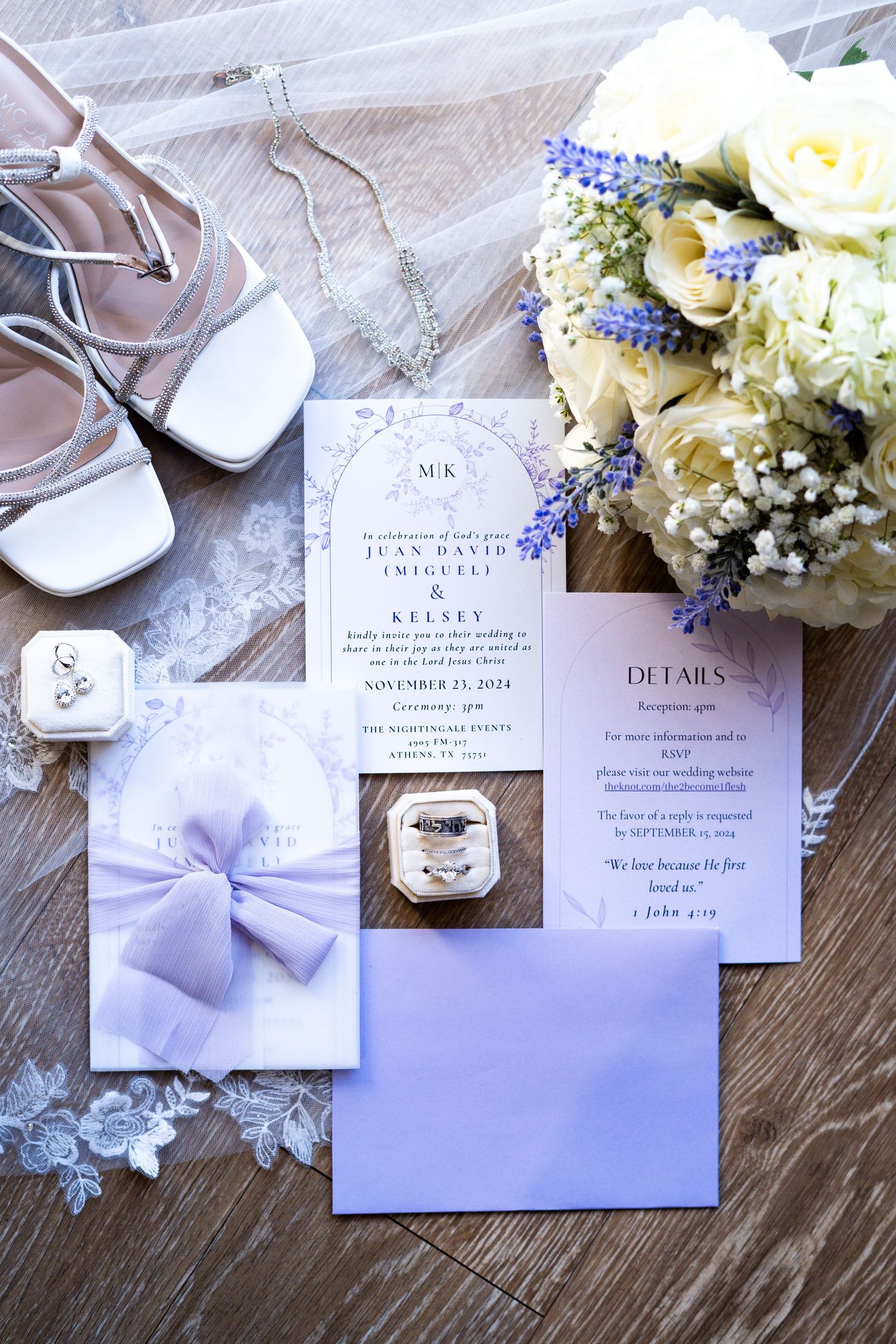Elegant wedding stationery set featuring purple bow, white lace, and delicate floral details.
