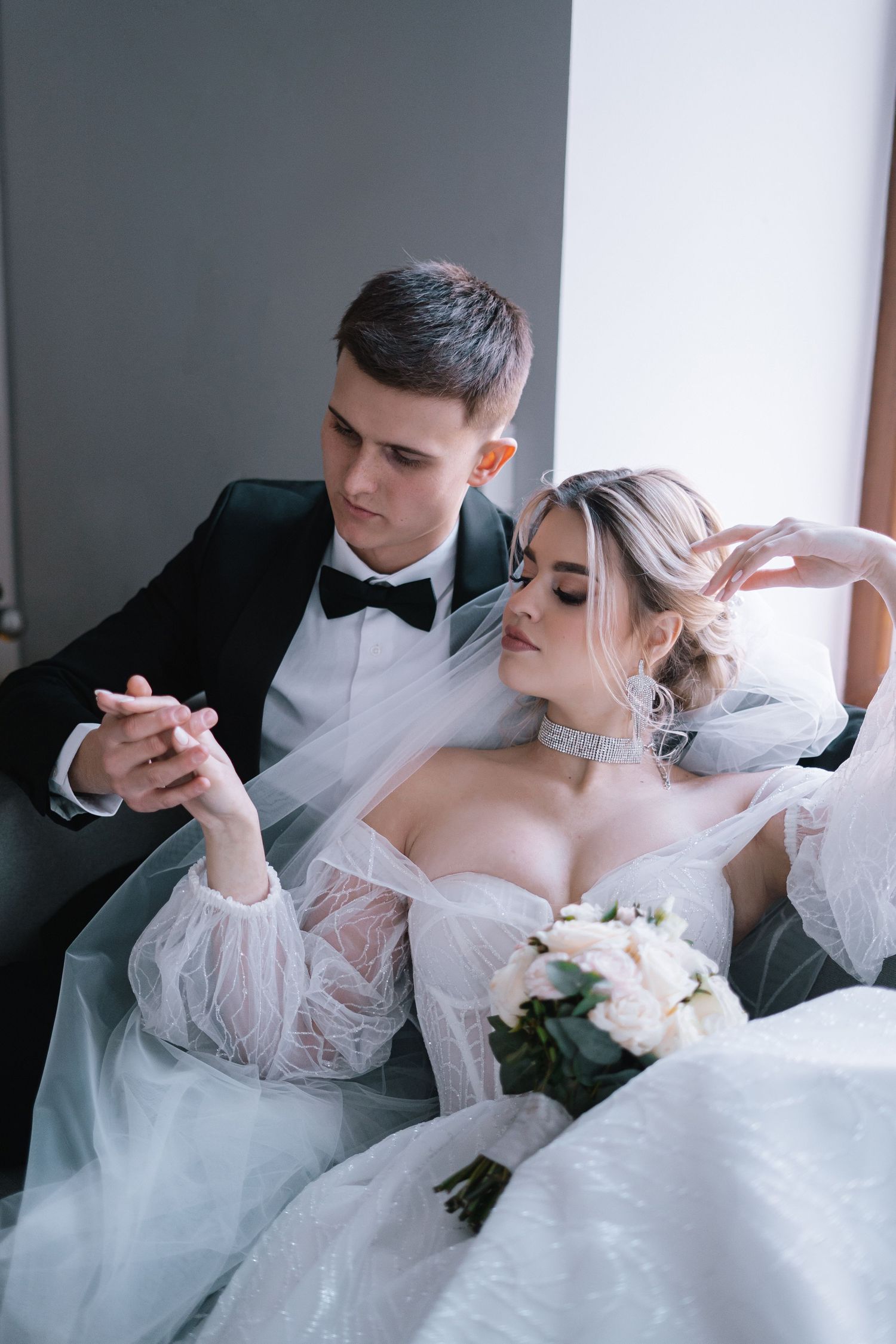 A romantic wedding couple shares intimate moments in a series of elegant black and white portraits.