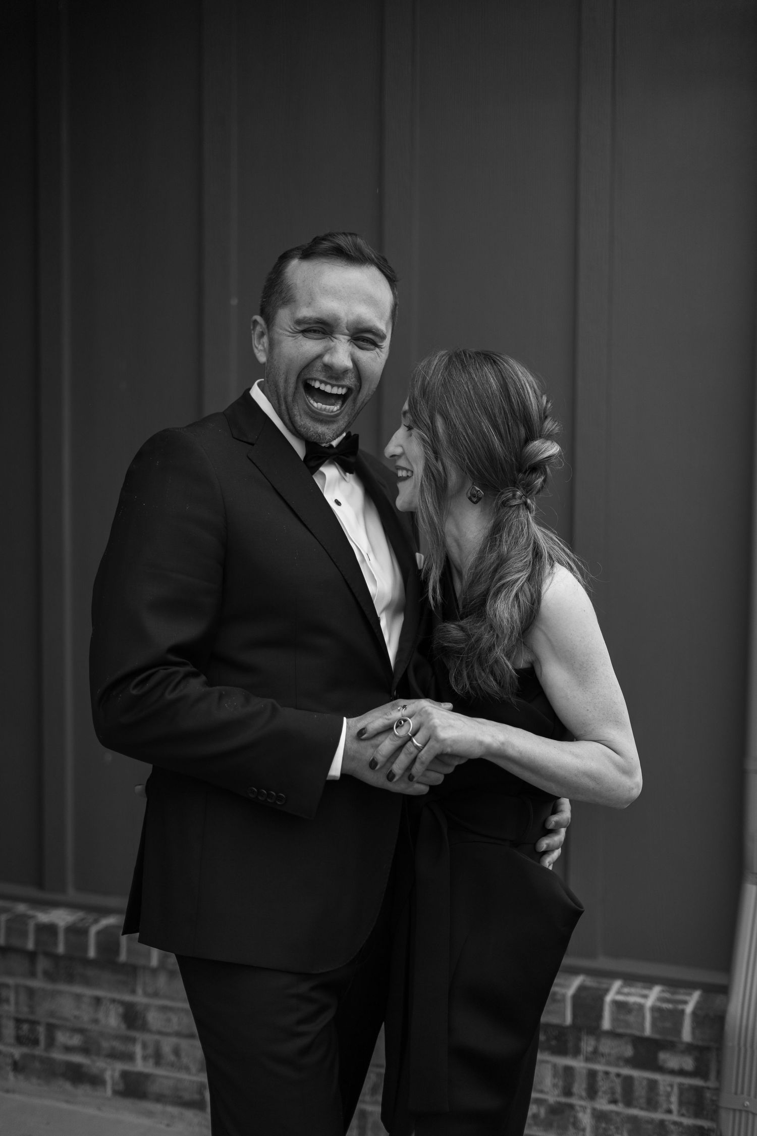 Black and white series of a couple laughing and dancing in formal attire.