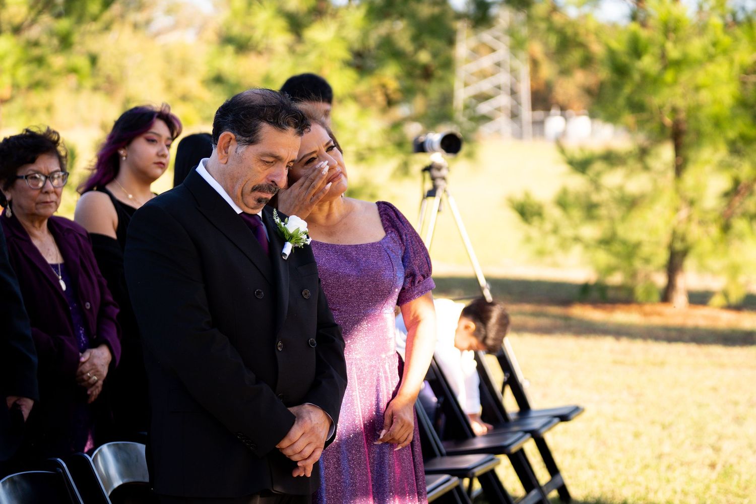 Wedding ceremony guests gathered outdoors during an autumn celebration.