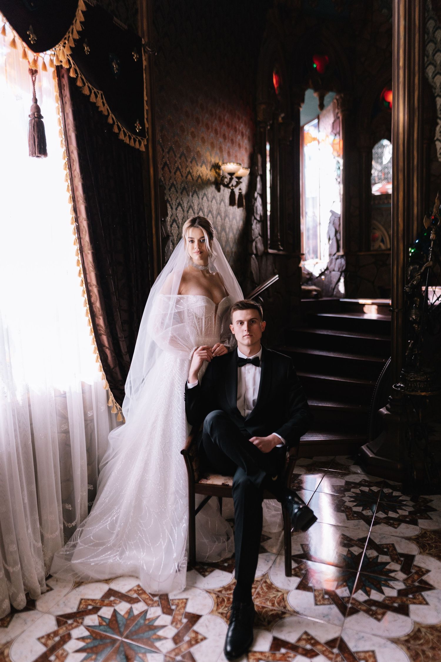 A series of four moody black and white wedding photos showing a couple in a vintage-style interior with patterned floors.