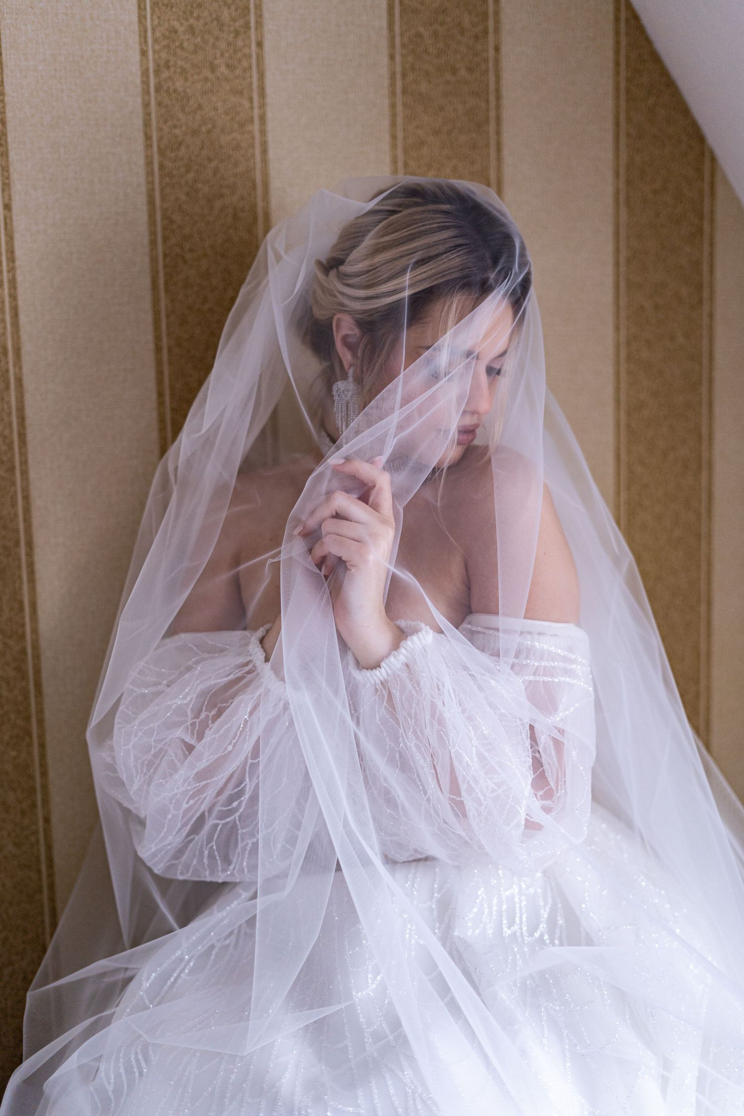 Four artistic shots of a bride wearing a delicate white lace dress and veil in soft, dreamy lighting.