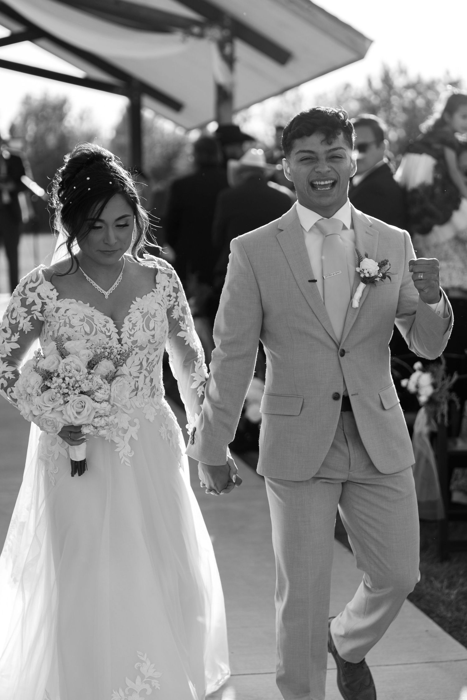Black and white wedding portraits showing joyful moments between couple and wedding party.