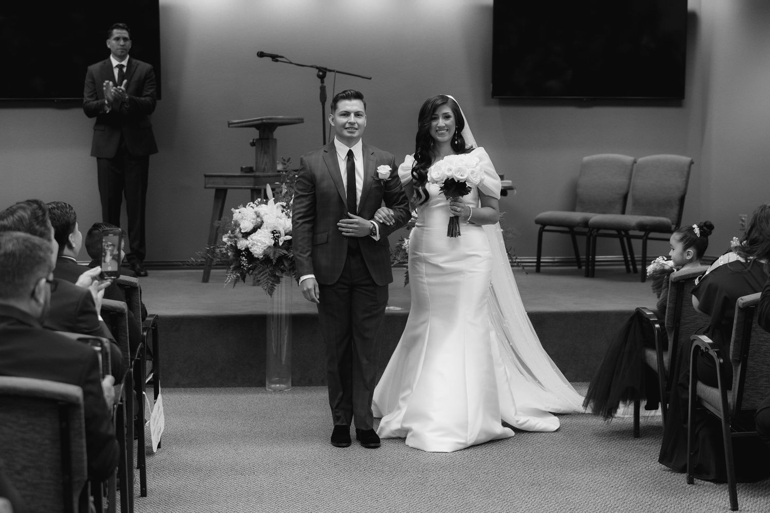 A series of black and white wedding ceremony photos showing intimate moments during a traditional church service.