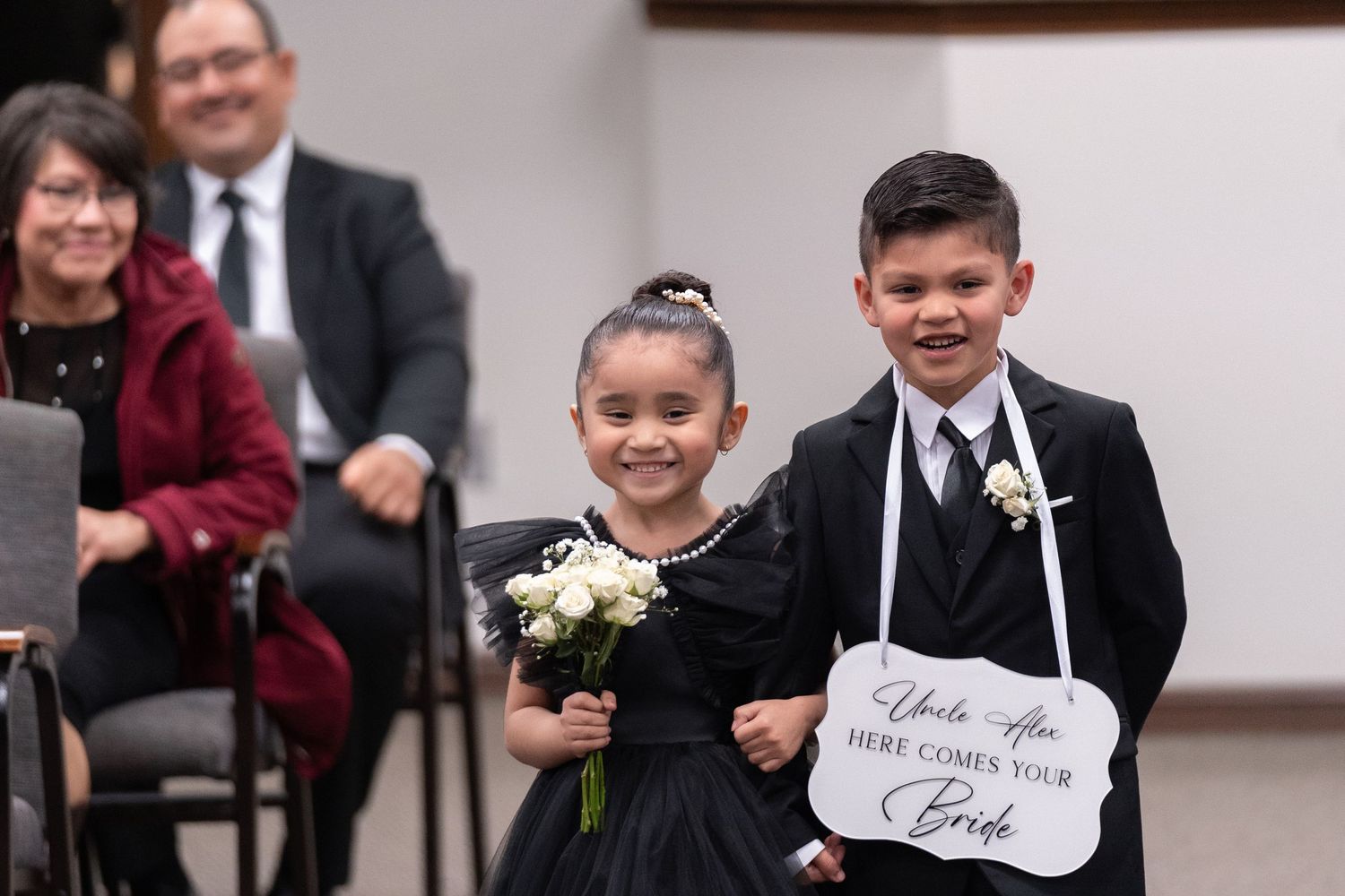 A collection of wedding photos showing guests holding up signs and celebrating at a formal event.