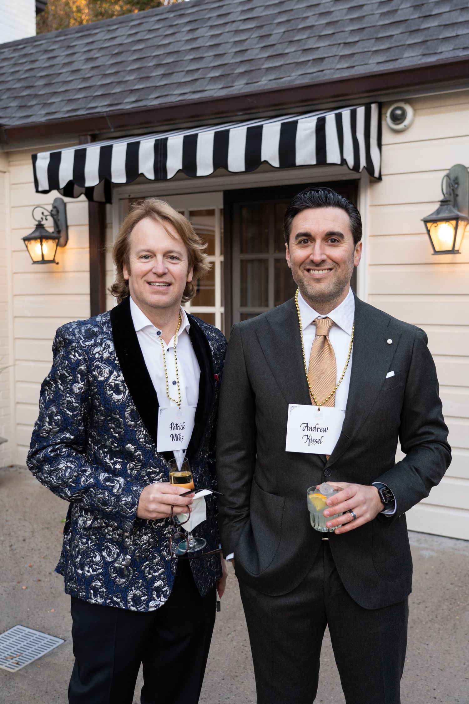 Guests in formal attire enjoying cocktails at an evening event.