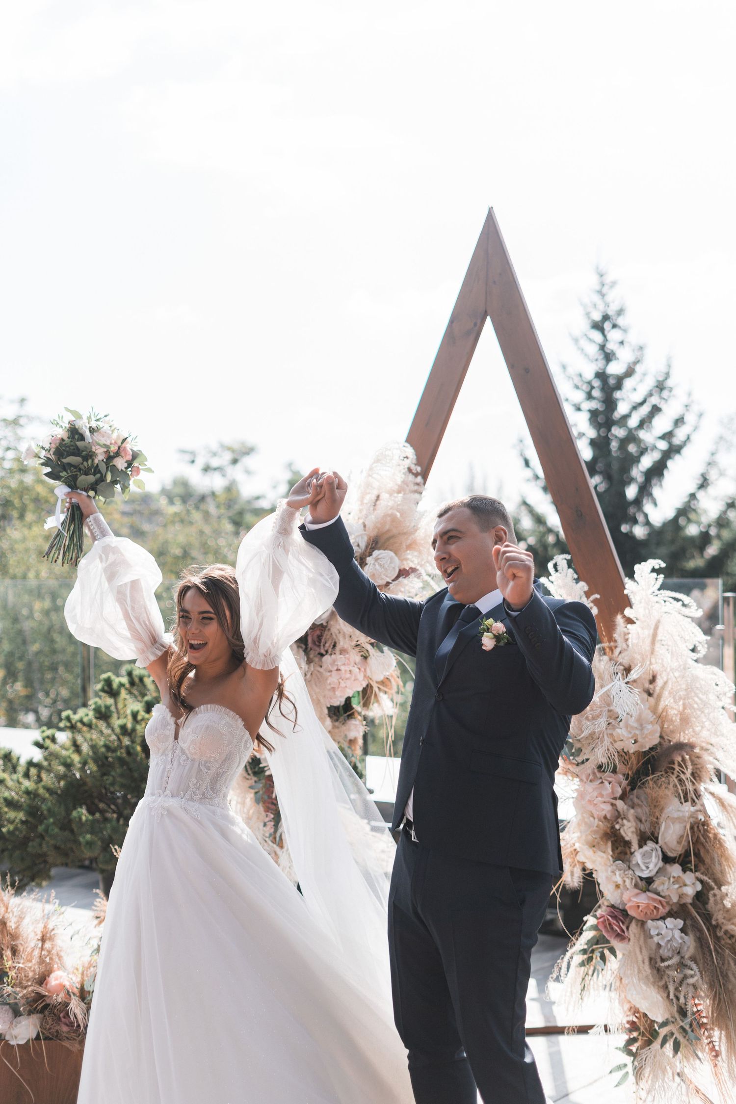 Joyful wedding celebration sequence showing couple and guests tossing dried flowers in outdoor winter setting.