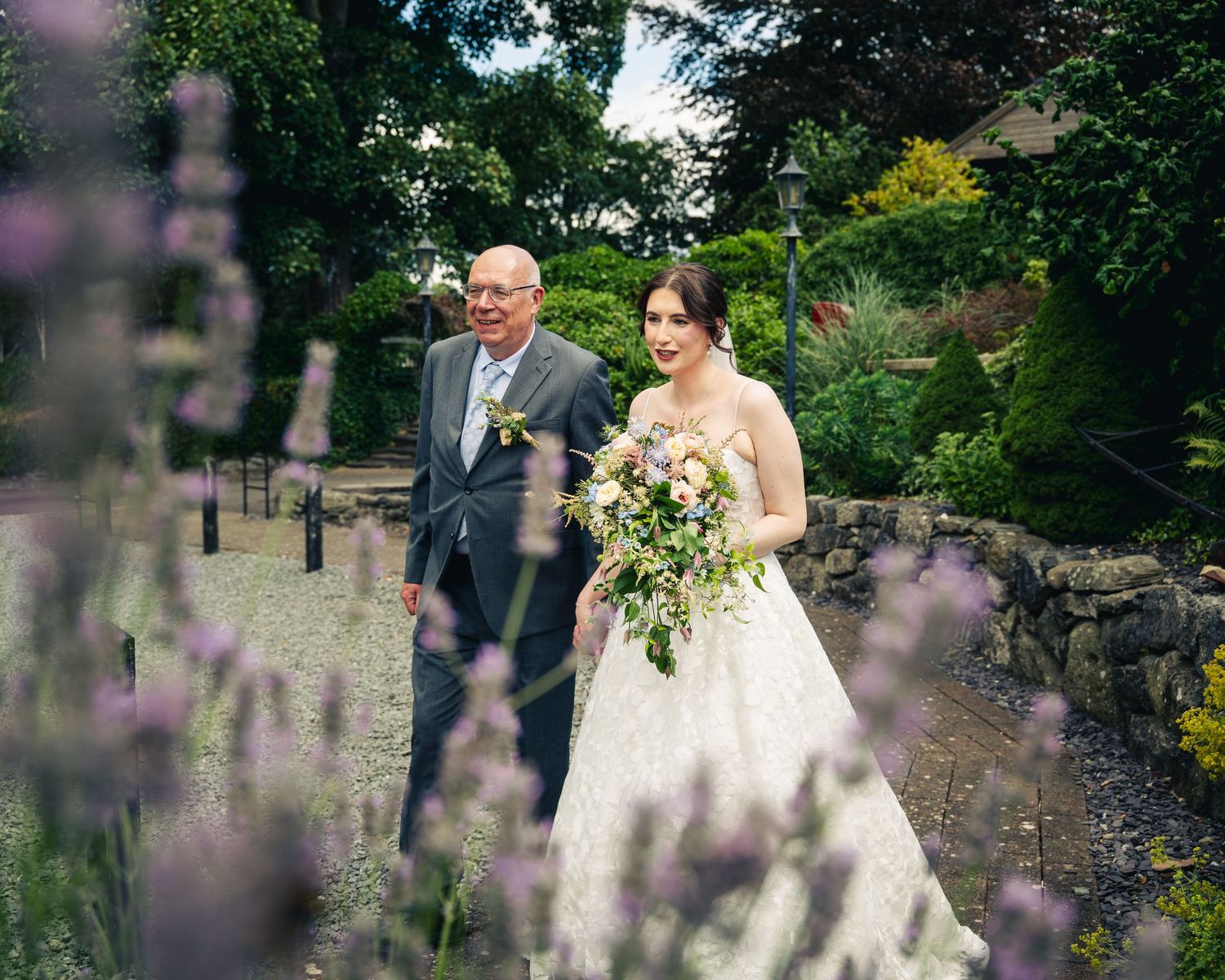 bride and father of the bride walking into the venue
