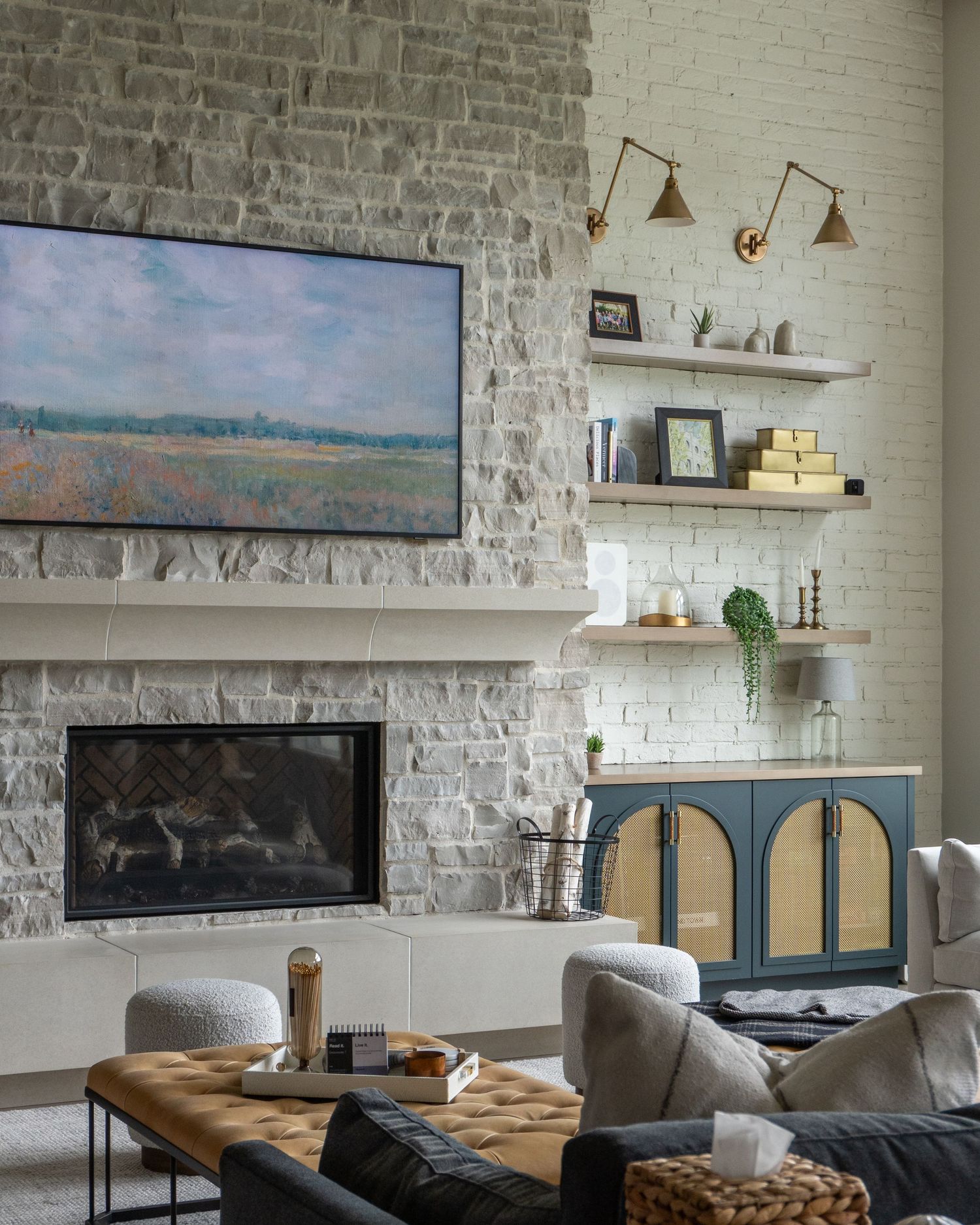 Living Room add-on of existing house with stone fireplace and custom built in shelves, flanking the fireplace taken by Molly Evans Photo