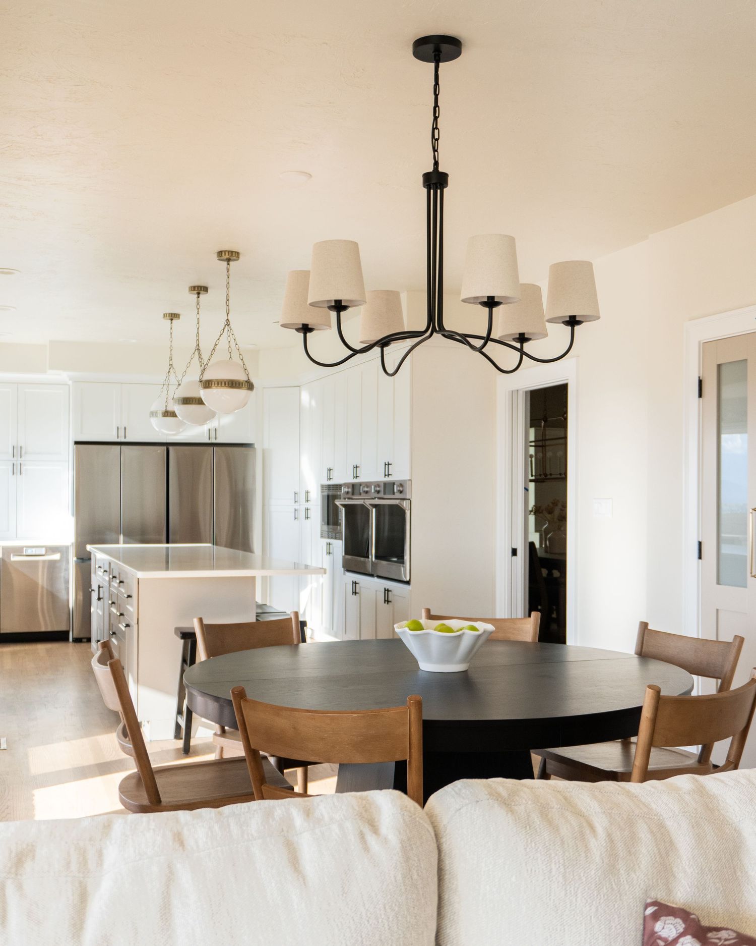 Renovated dining room and kitchen in a historic Provo Utah home full of natural light, and custom pendants