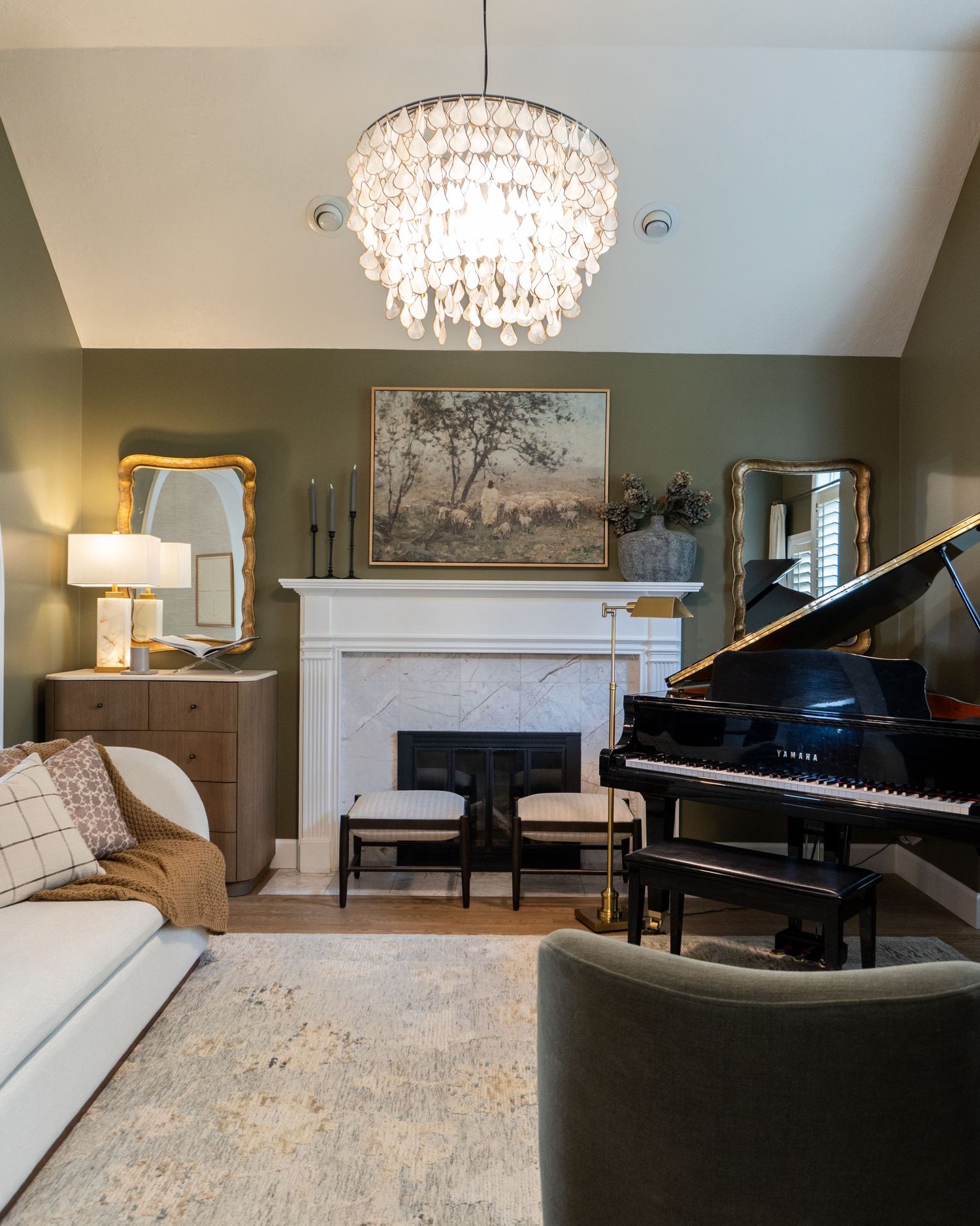 Moody lighting by a chandelier and lamp in a front room focused on music and family time