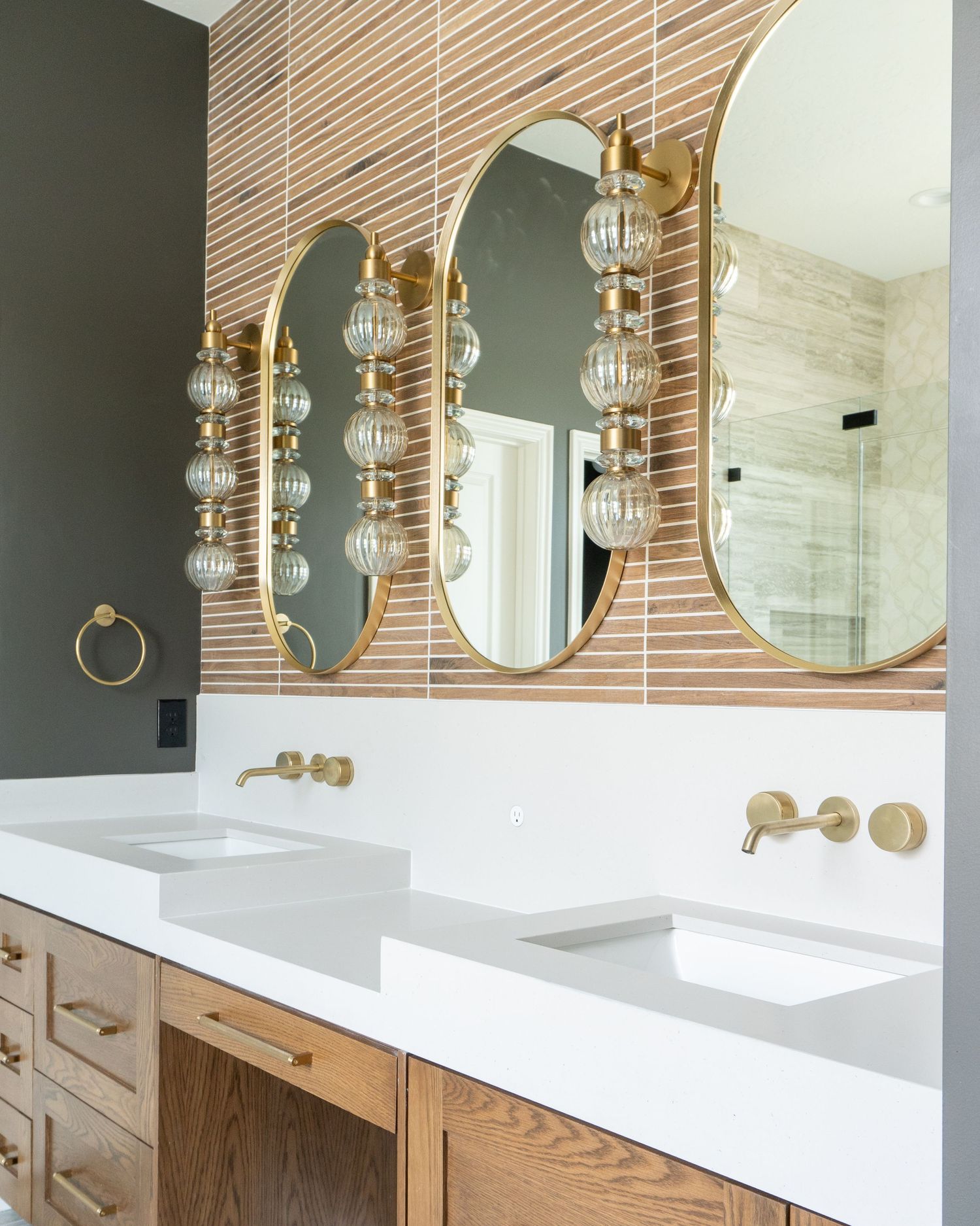 Primary suite bathroom with double sink vanity and custom tile and countertops in Provo Utah.