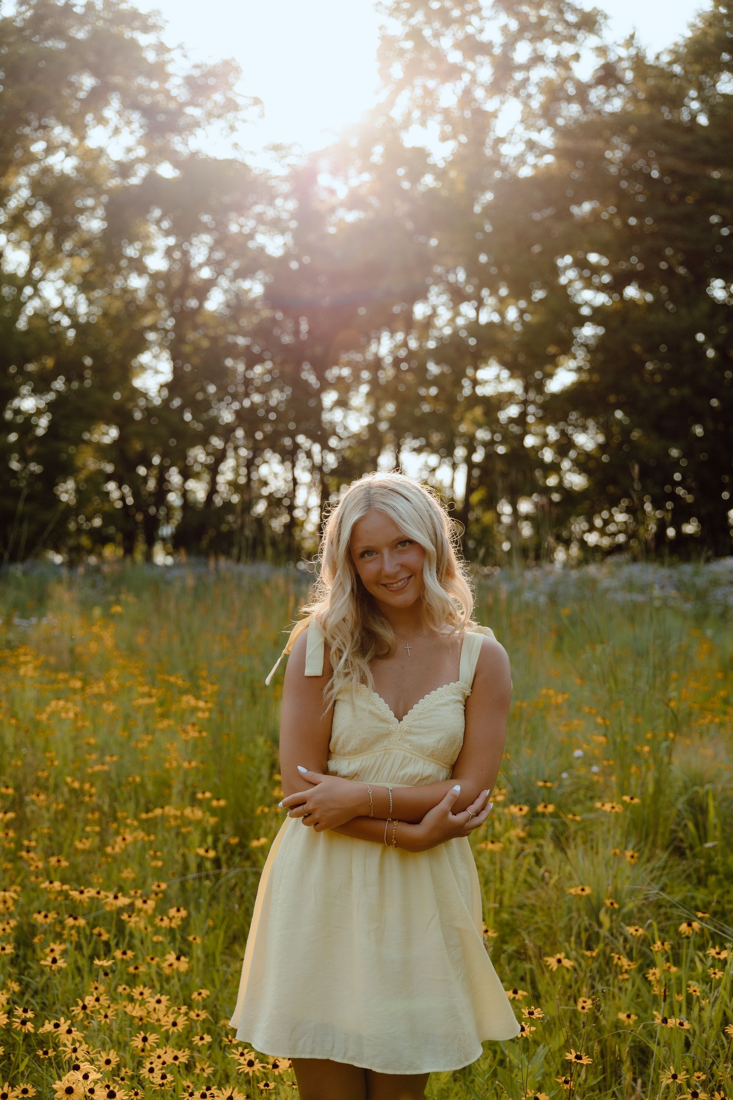 Romantic sunset portrait in a cream dress surrounded by summer wildflowers.