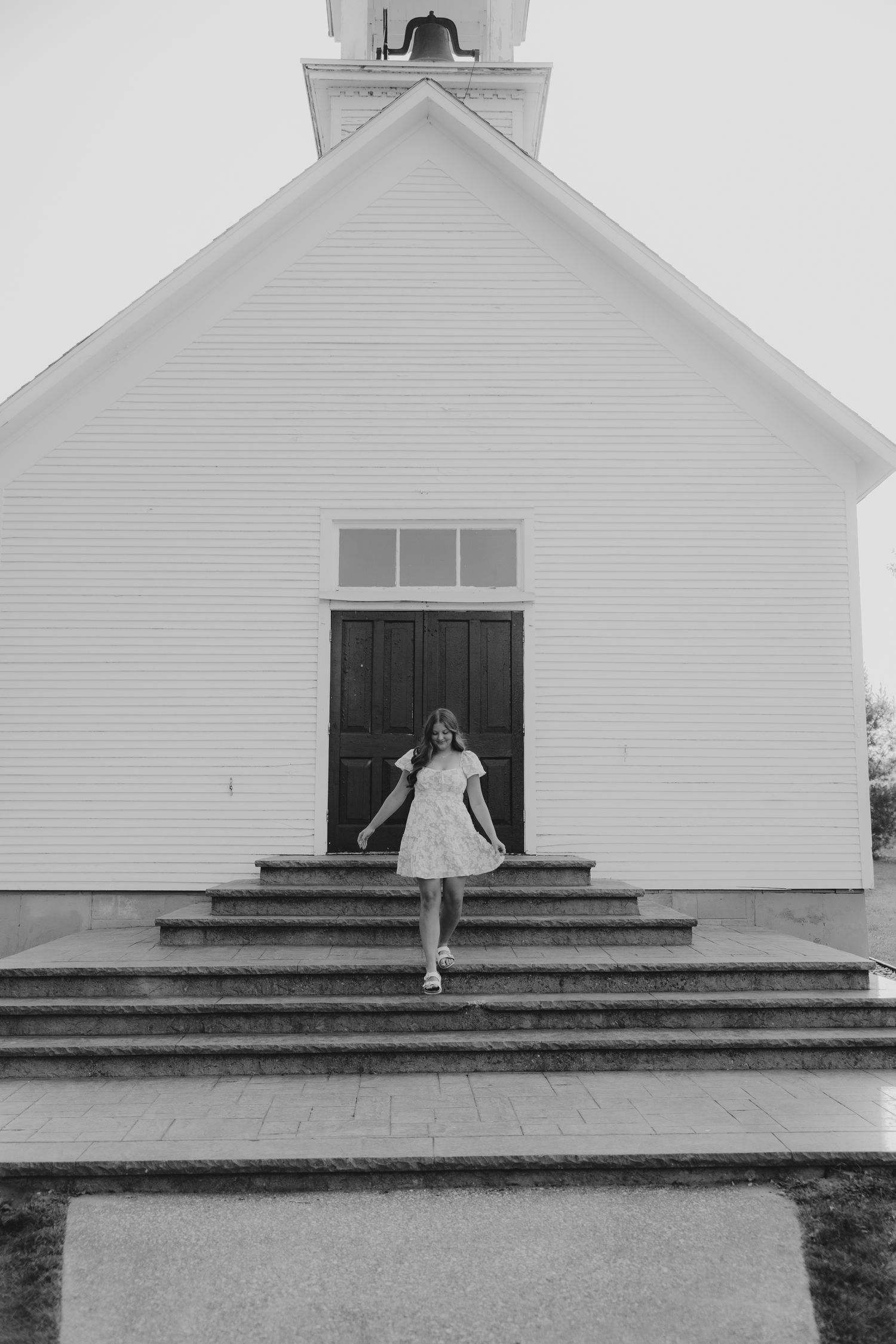 Black and white photo series showing a white church building with steps and architectural details.