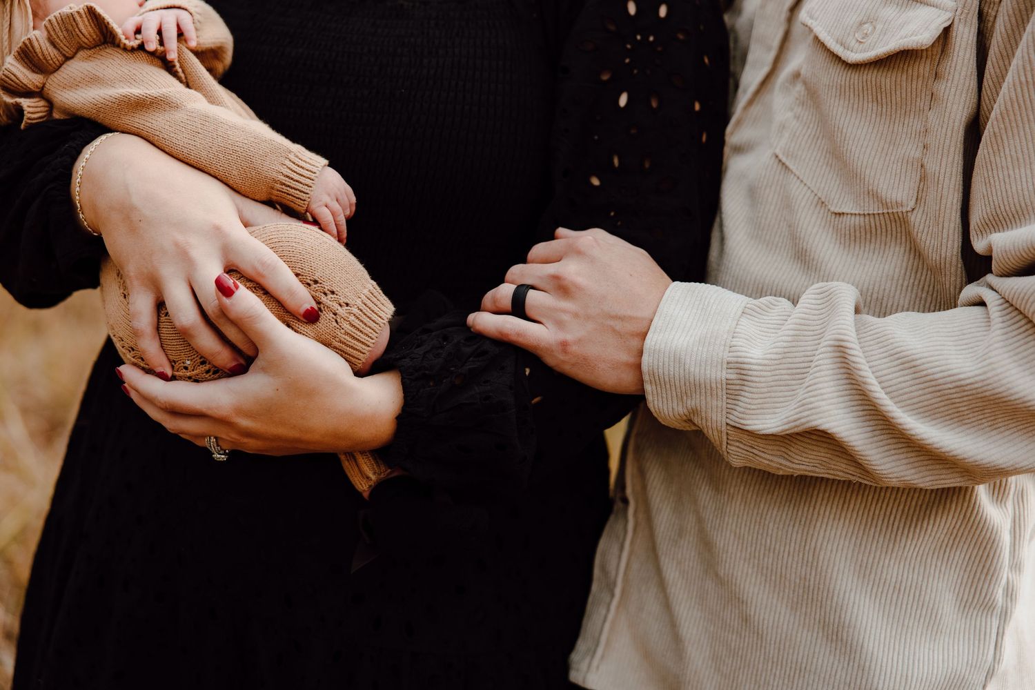 Gentle hands holding and caring in warm neutral tones.