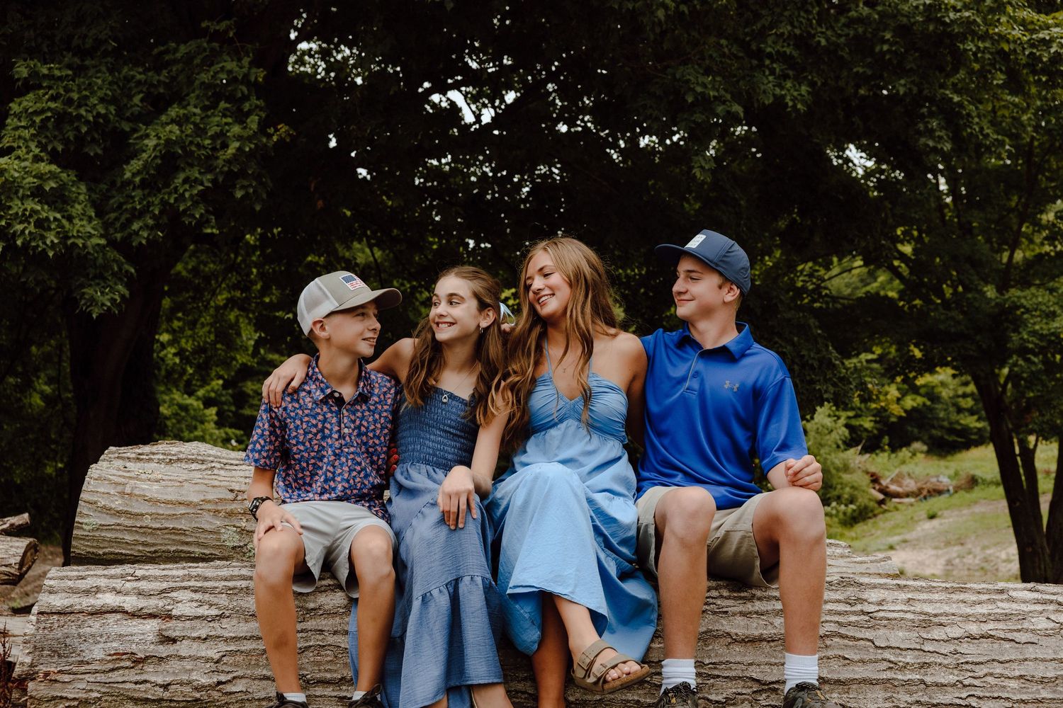 Family members sit together on stone steps during an outdoor gathering.