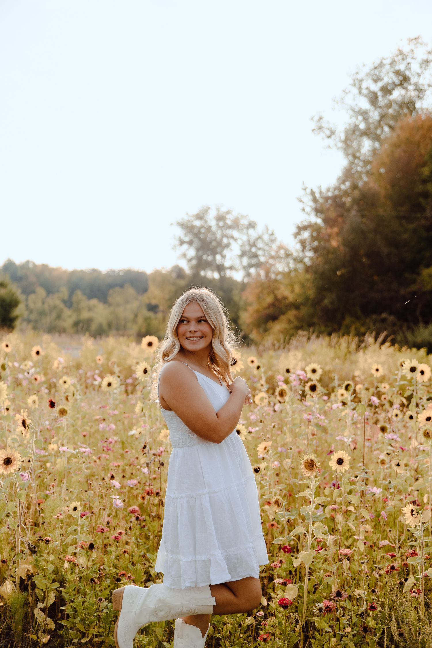 Beautiful portrait session in a sunlit wildflower field with yellow blooms.