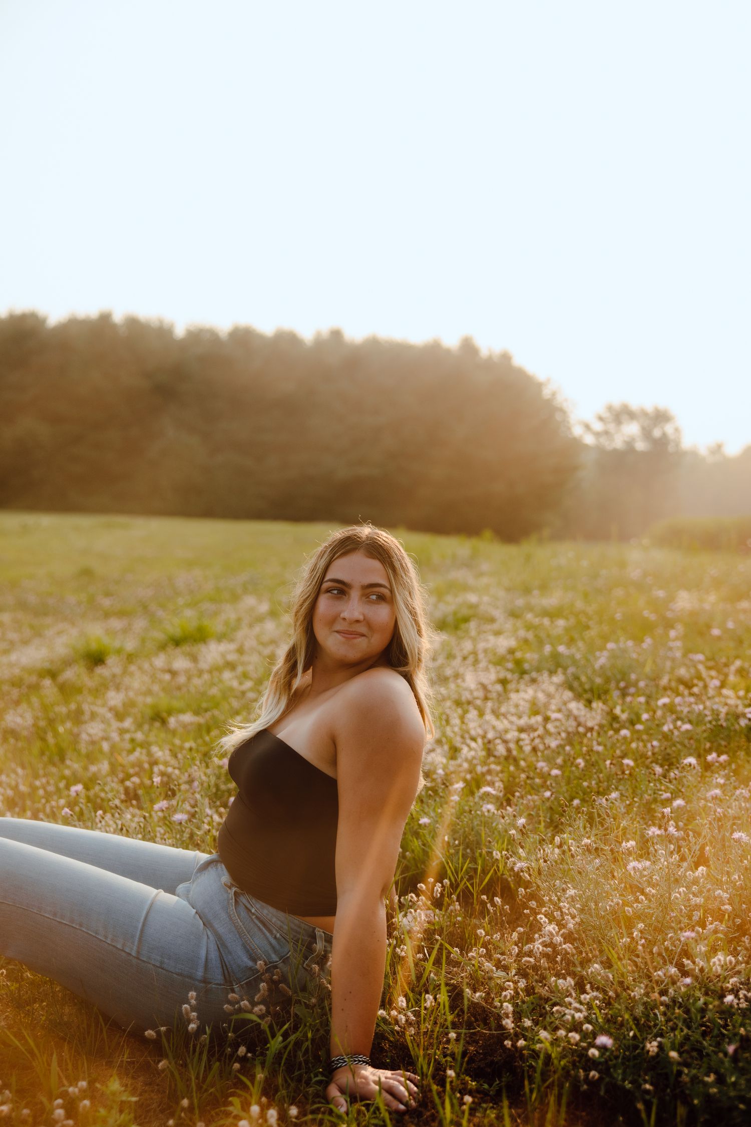 A golden sunset photoshoot in a wildflower field creates a dreamy summer atmosphere.