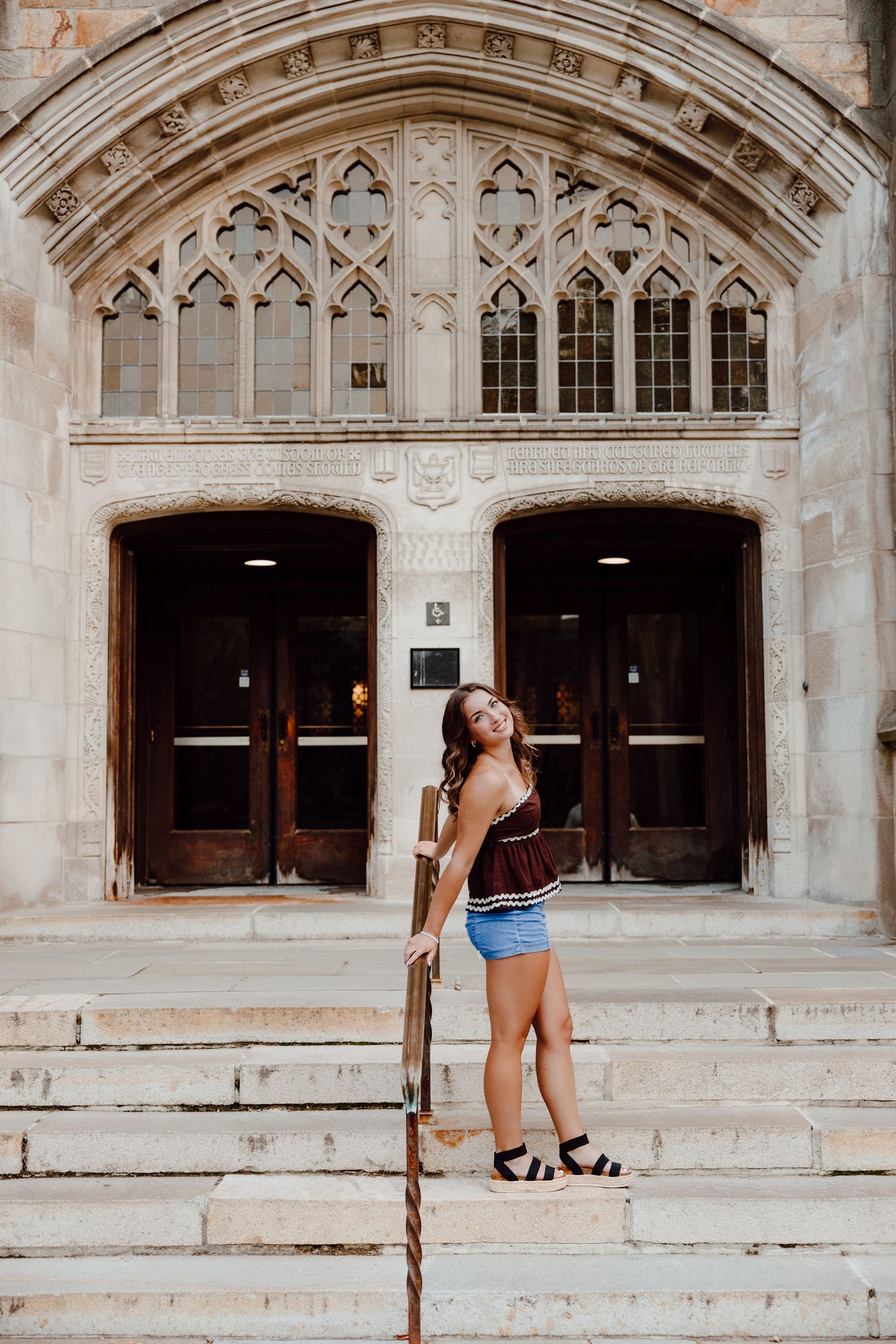 A series of Gothic archways and stone steps create an elegant architectural scene.