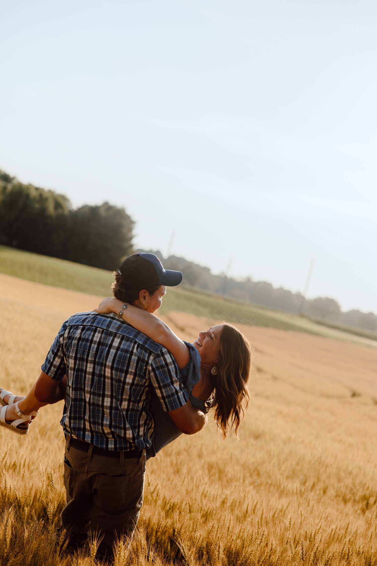A romantic dance sequence in a golden wheat field during sunset.