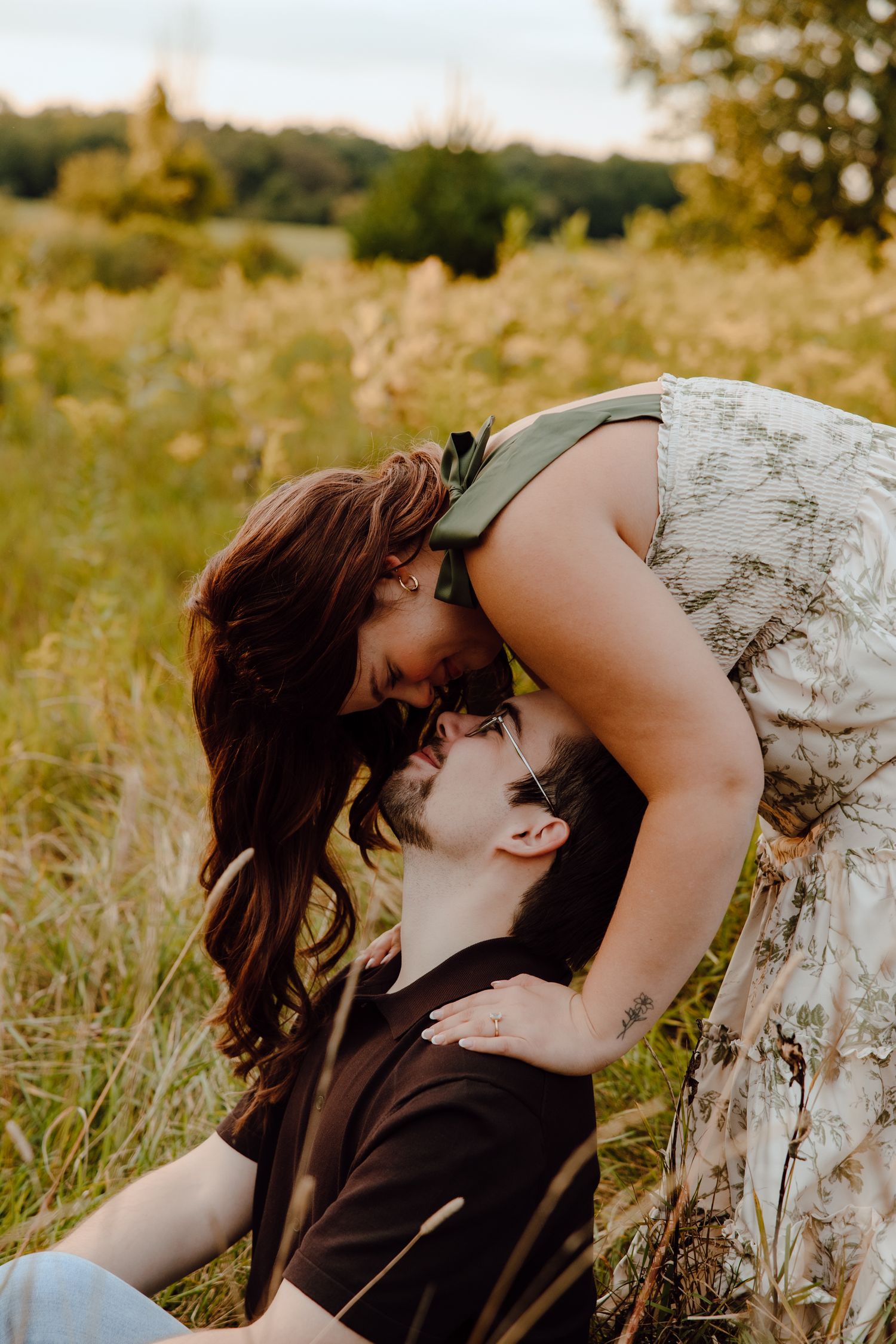 A romantic dip pose captured during sunset in a wildflower meadow.