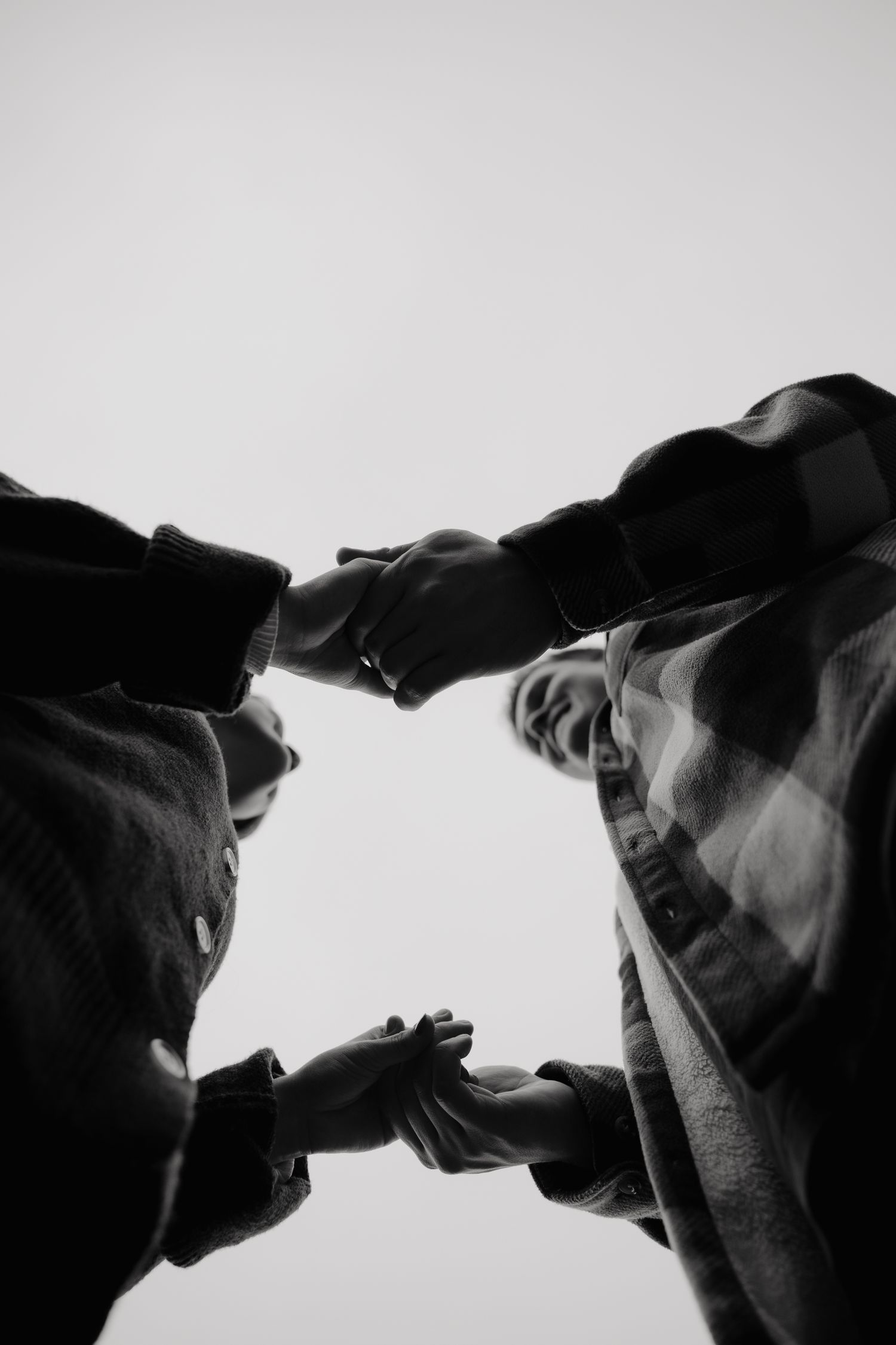 An artistic black and white low angle portrait of a couple.
