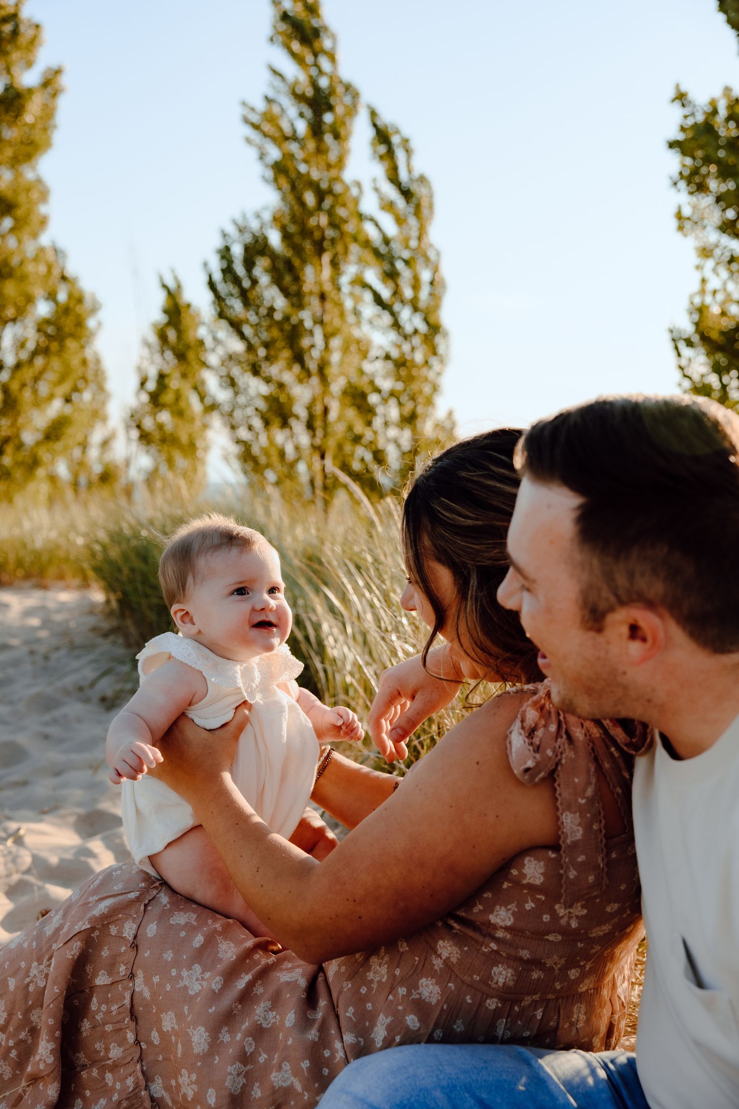 Candid family interactions captured during sunset at the beach.