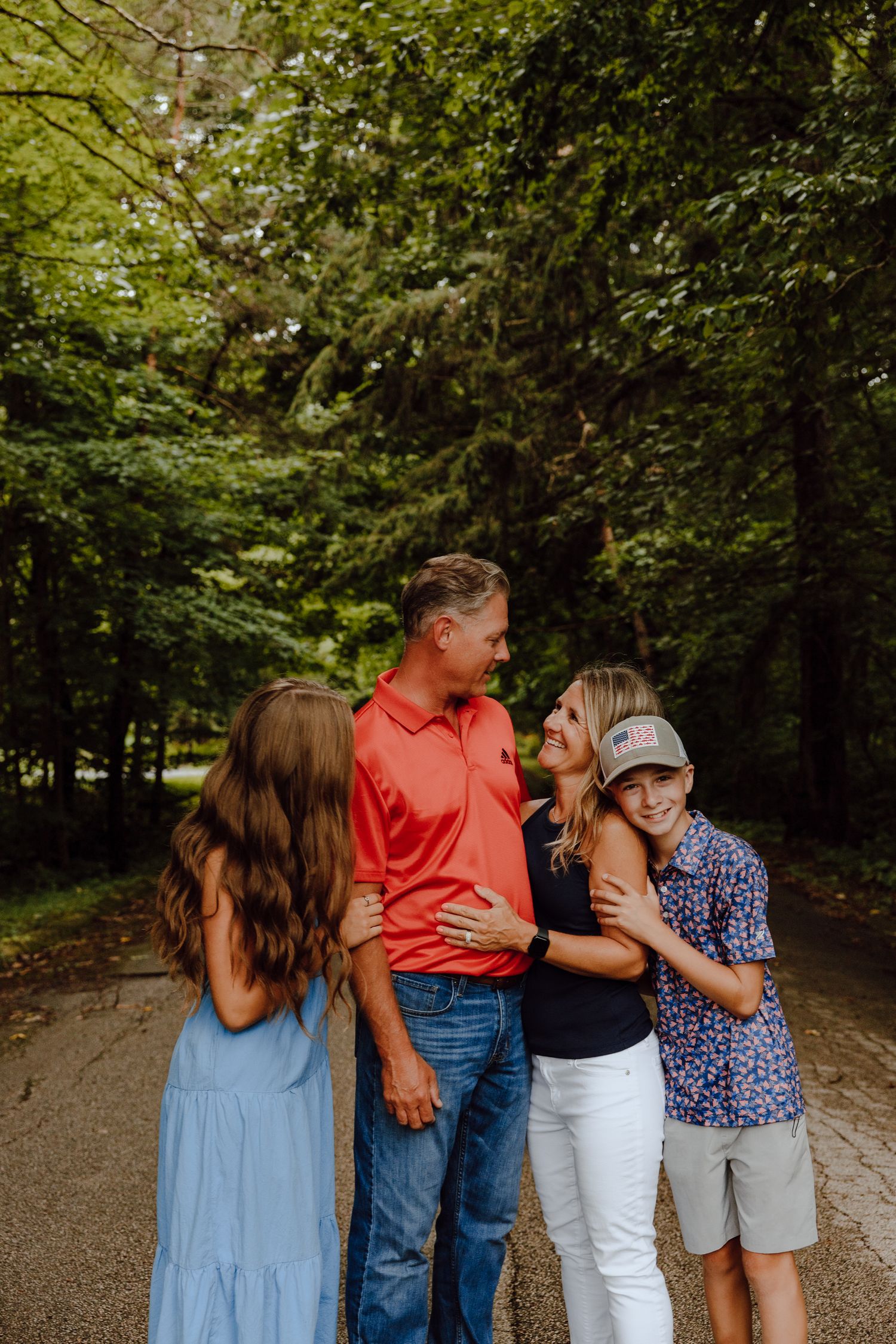 Group photo of family members in coordinated blue and red outfits standing together outdoors.