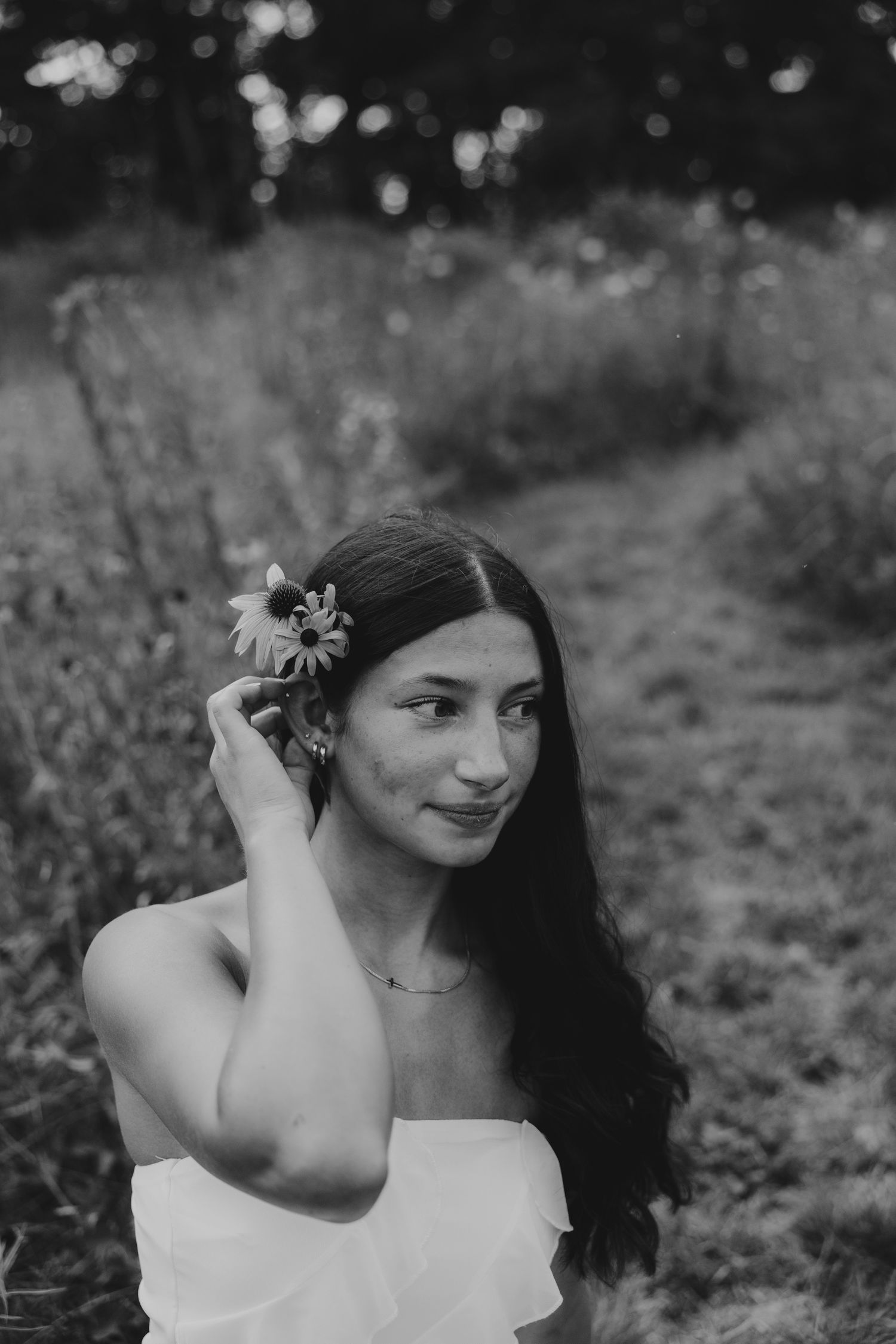 Black and white portrait series with dreamy bokeh background in nature.
