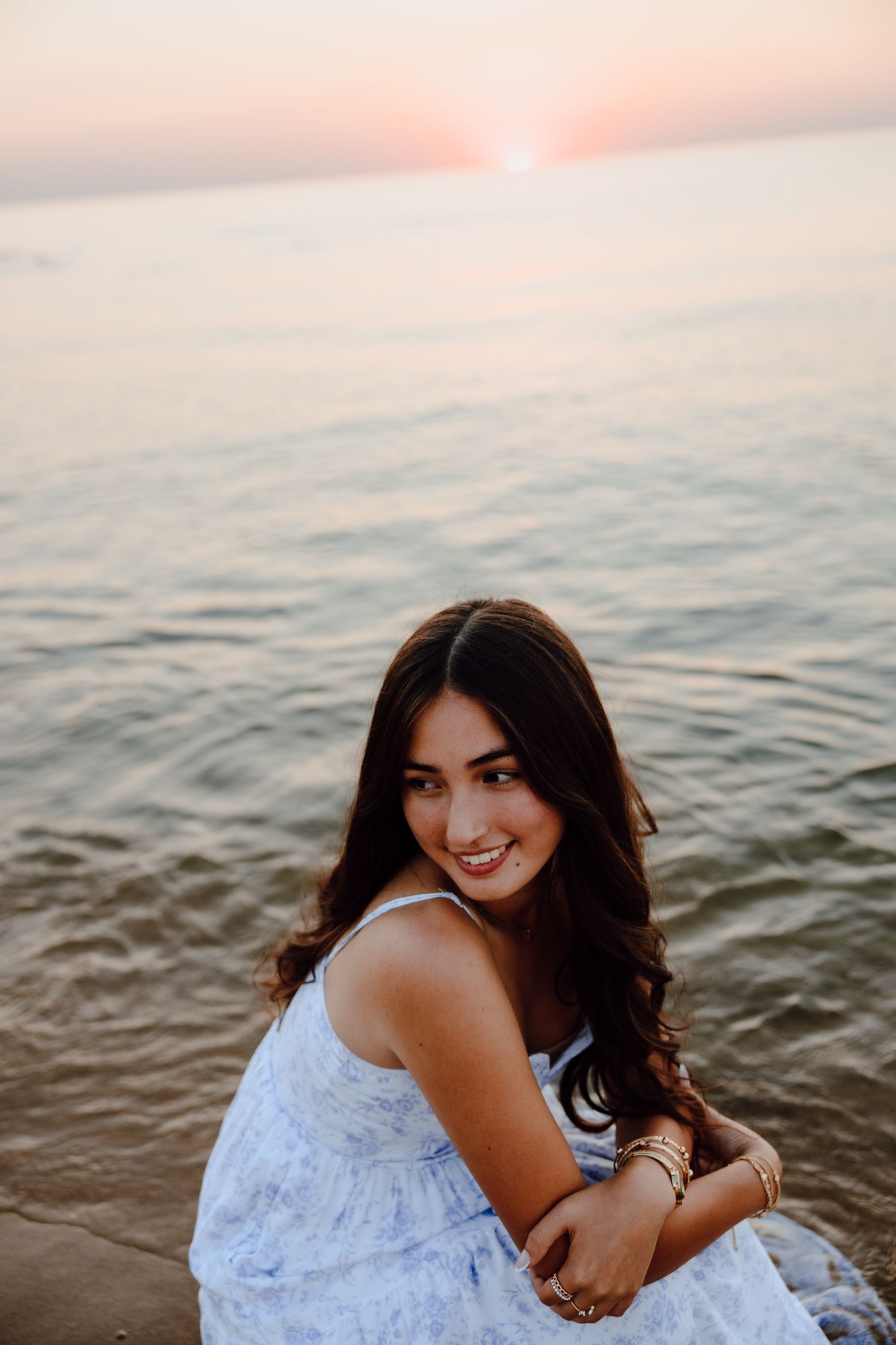 A joyful beach photoshoot moment captured during sunset.