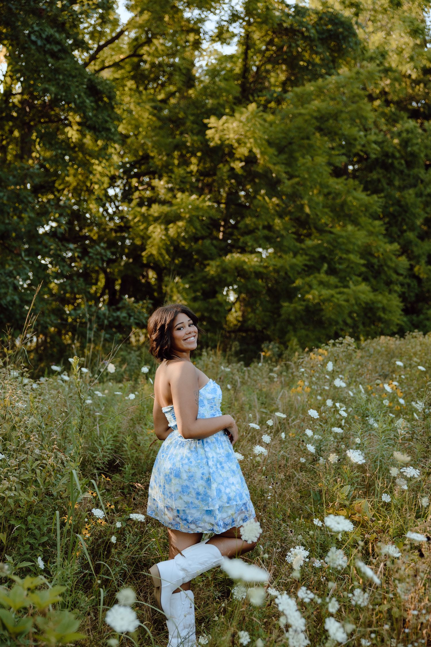 A dreamy portrait session in a meadow filled with white wildflowers.
