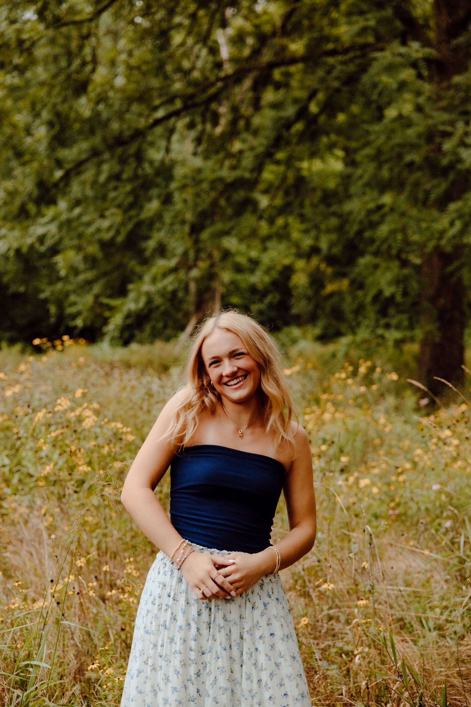 Candid moment captured in a summer field with wildflowers and natural lighting.