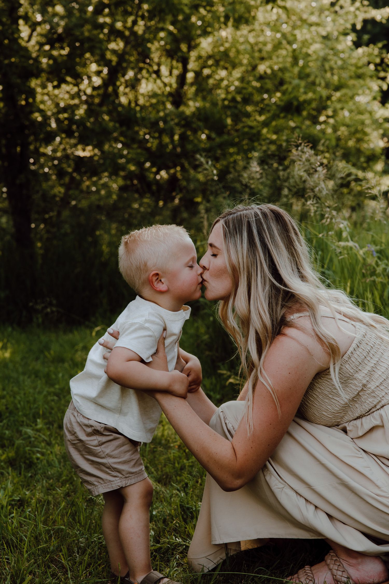 Tender moment shared between parent and child in a lush garden setting.