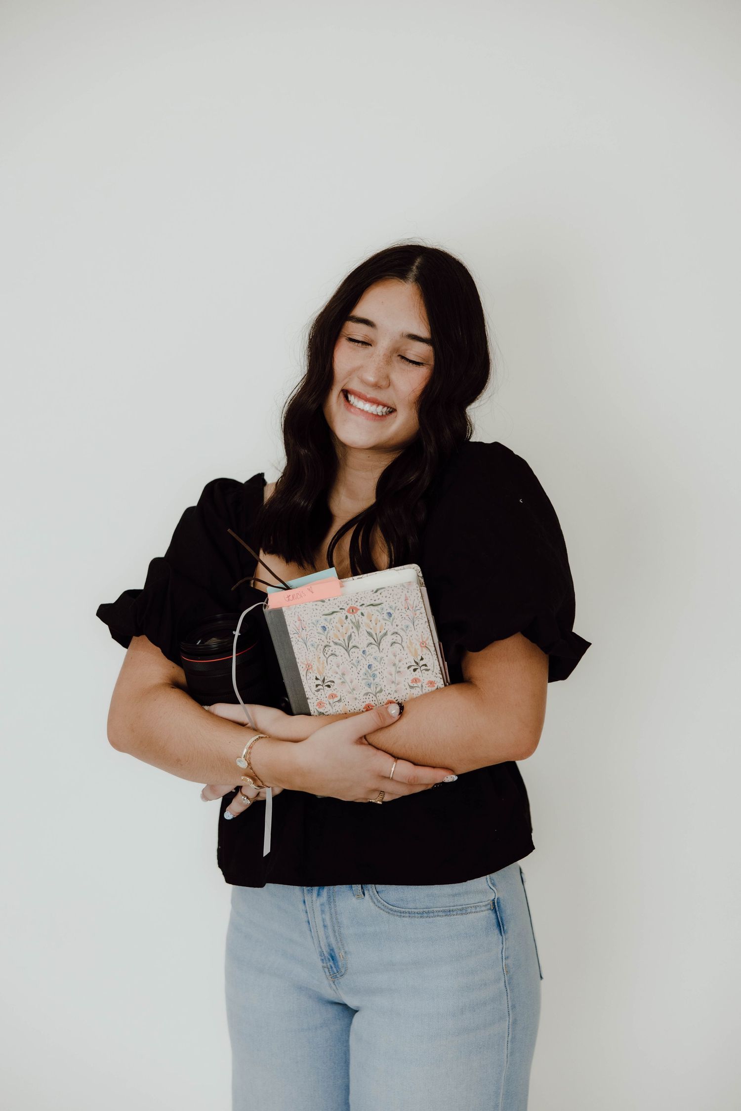Casual studio portraits showing genuine happiness while holding decorative items.