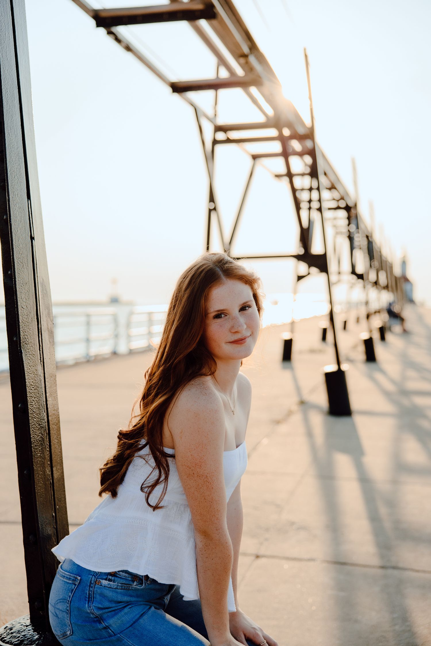 Sunlight casts dramatic shadows on a wooden pier during a summer photoshoot.