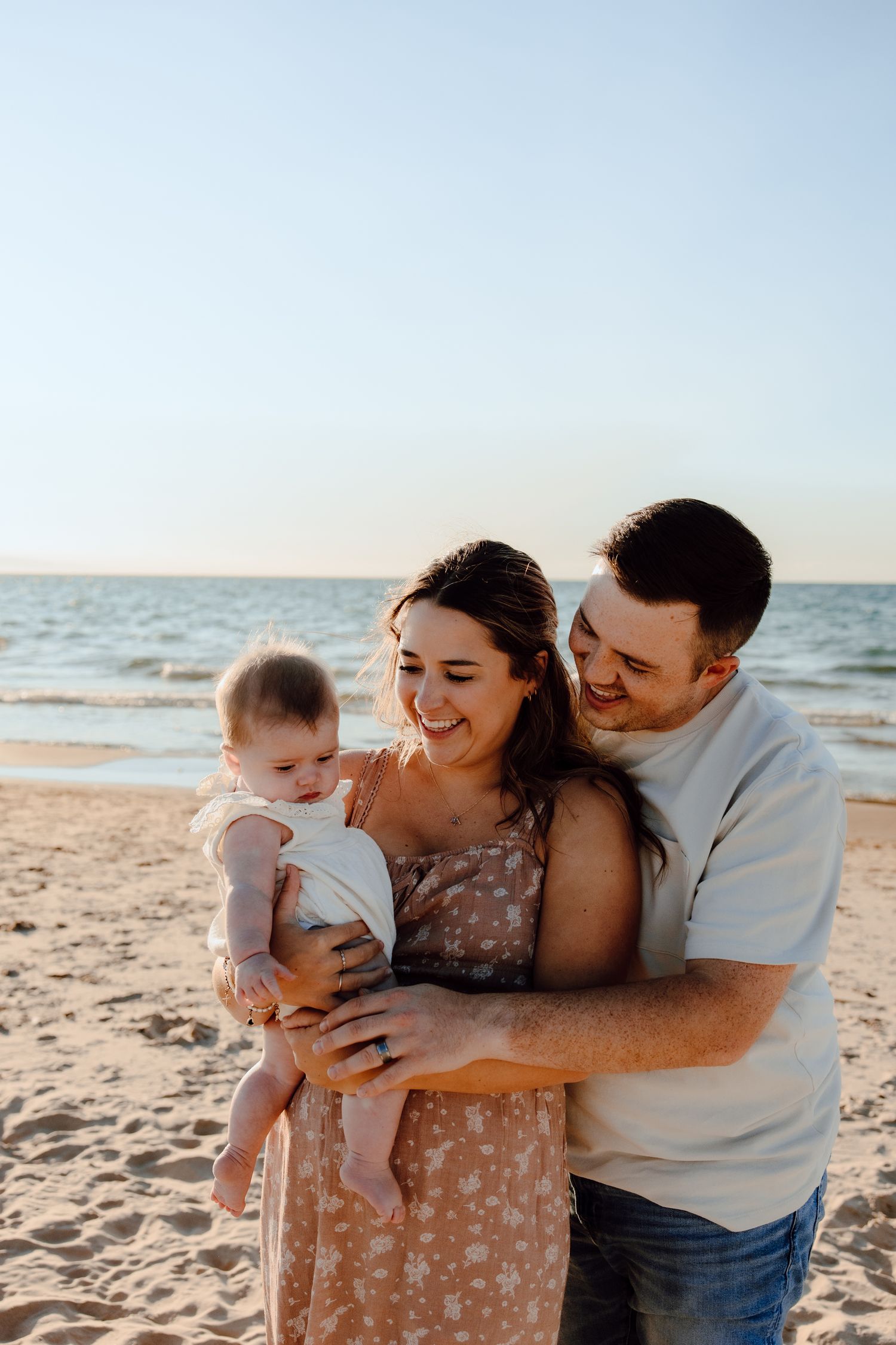 A tender family moment captured on the beach at sunset.