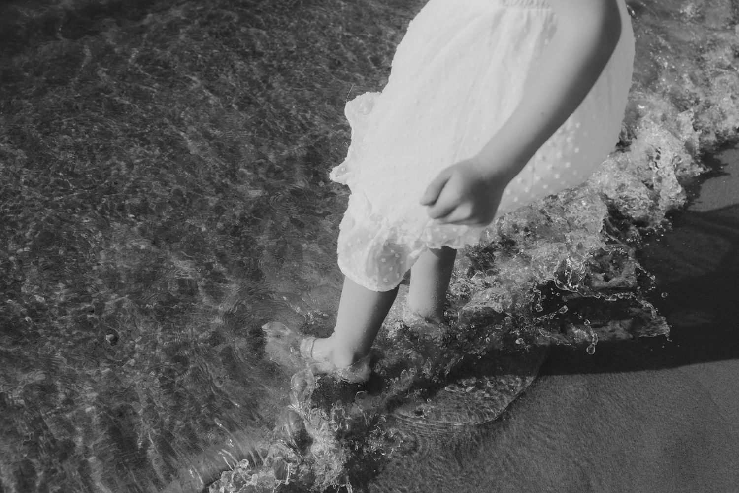 Black and white photos capture romantic moments on rocky coastal cliffs.