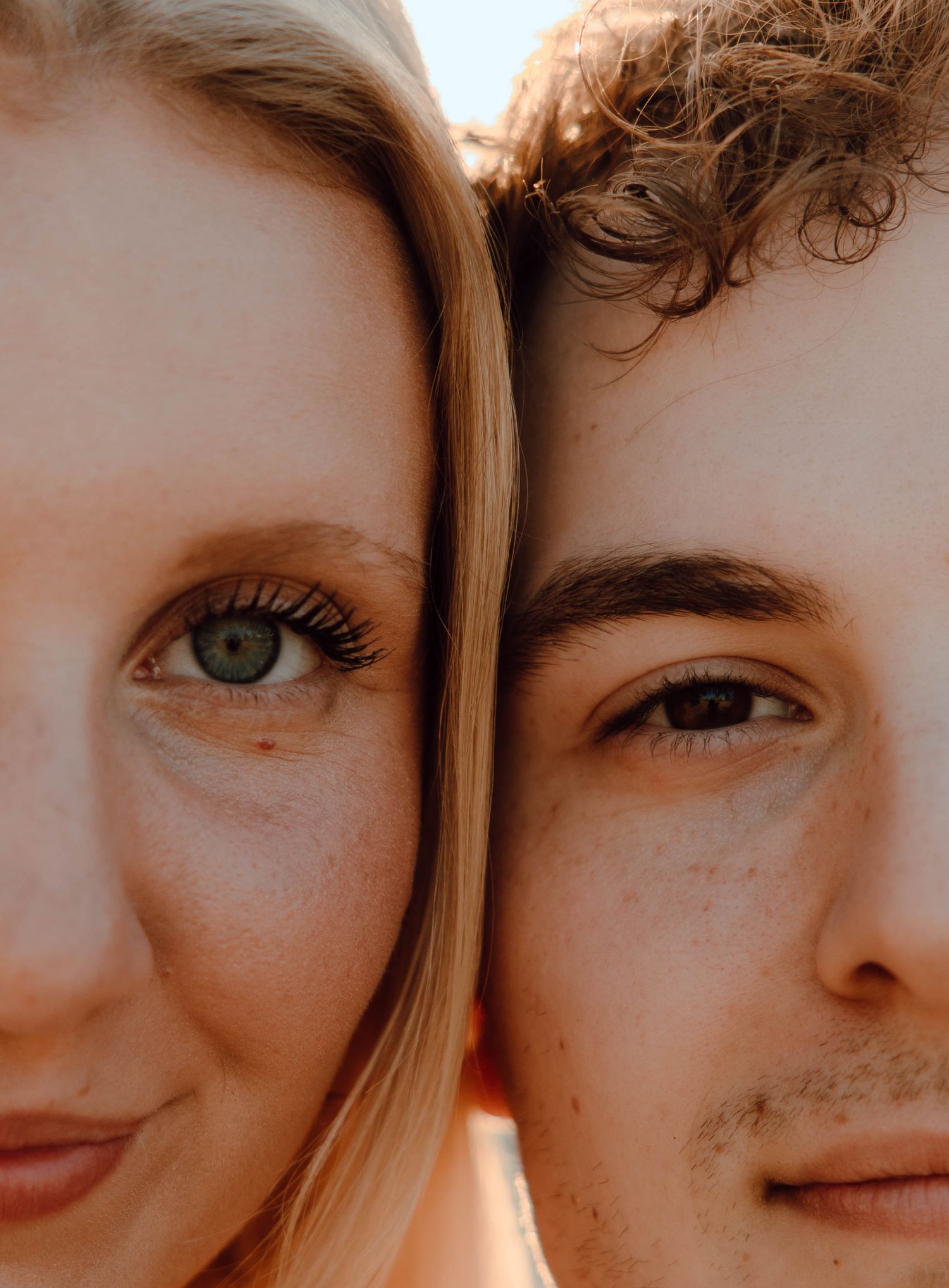 Close-up portrait of a blonde woman with green eyes and a curly-haired man with brown eyes side by side.